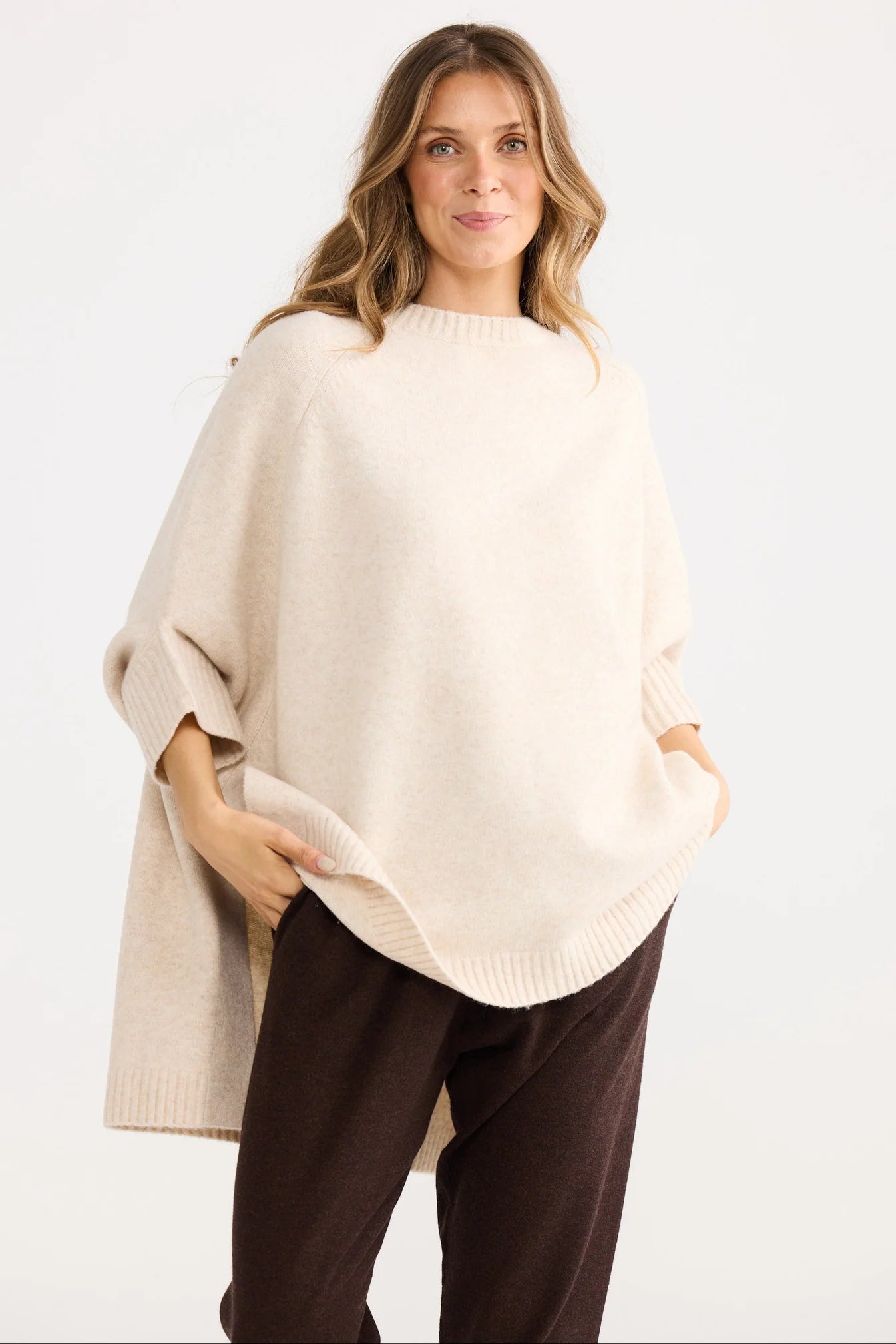 Collection of Woman wearing a Home Love beige poncho over a white background in a gallery layout