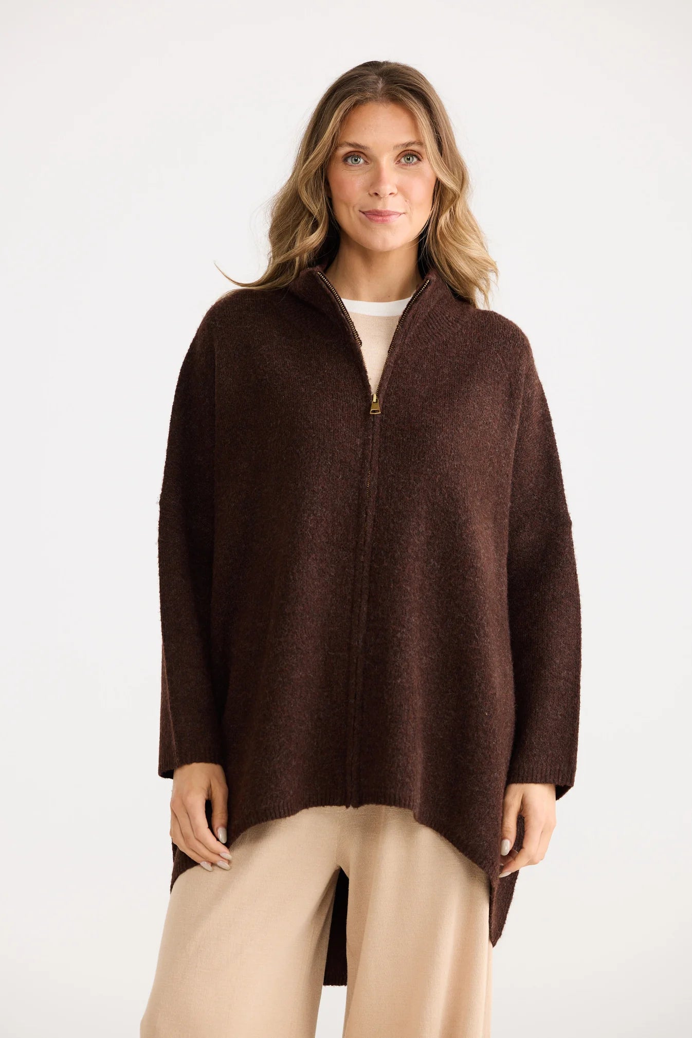 Woman wearing a Home Love brown poncho on a white background