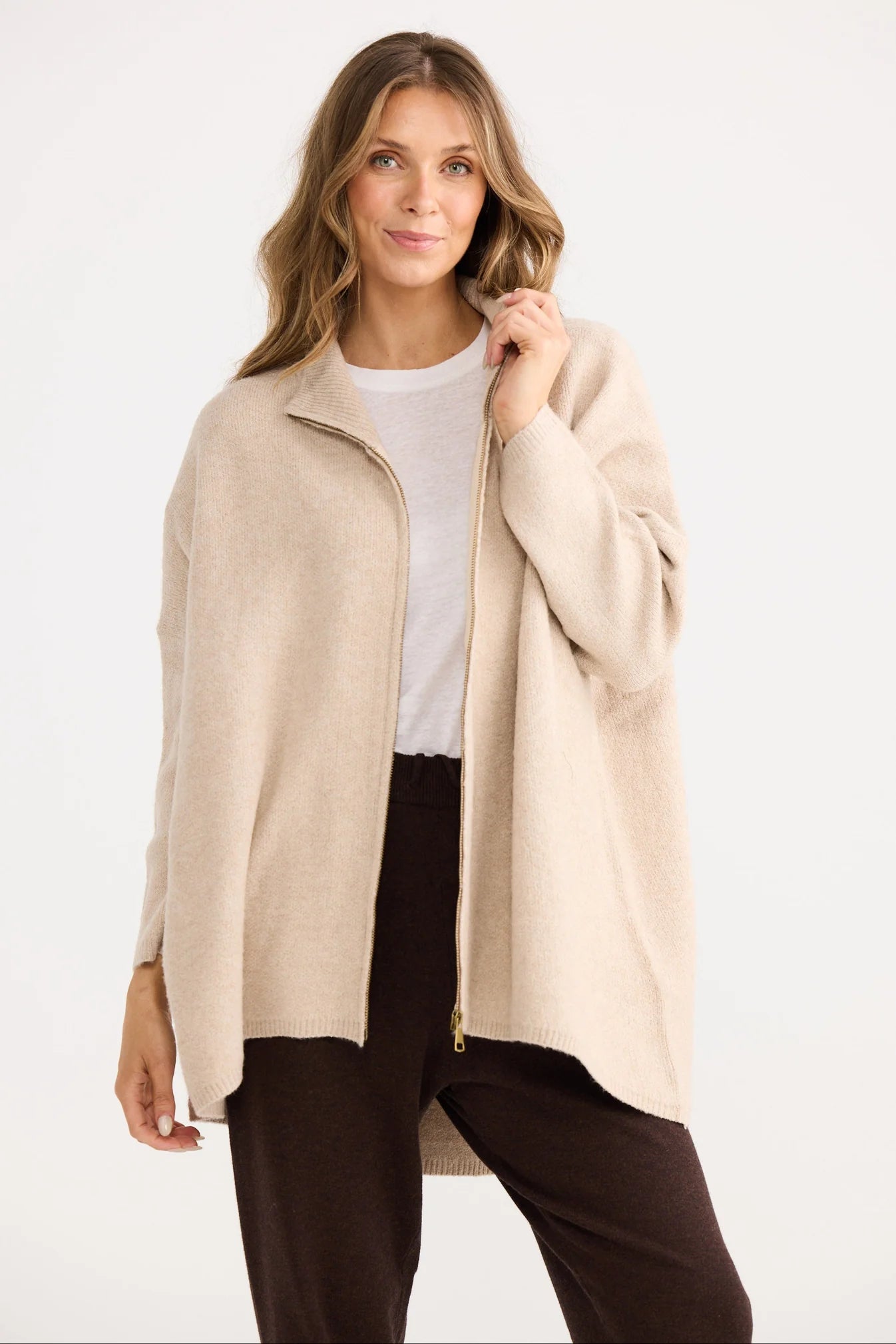 Collection of Woman wearing a Home Love beige cardigan over a white shirt and dark pants on a white background in a gallery layout