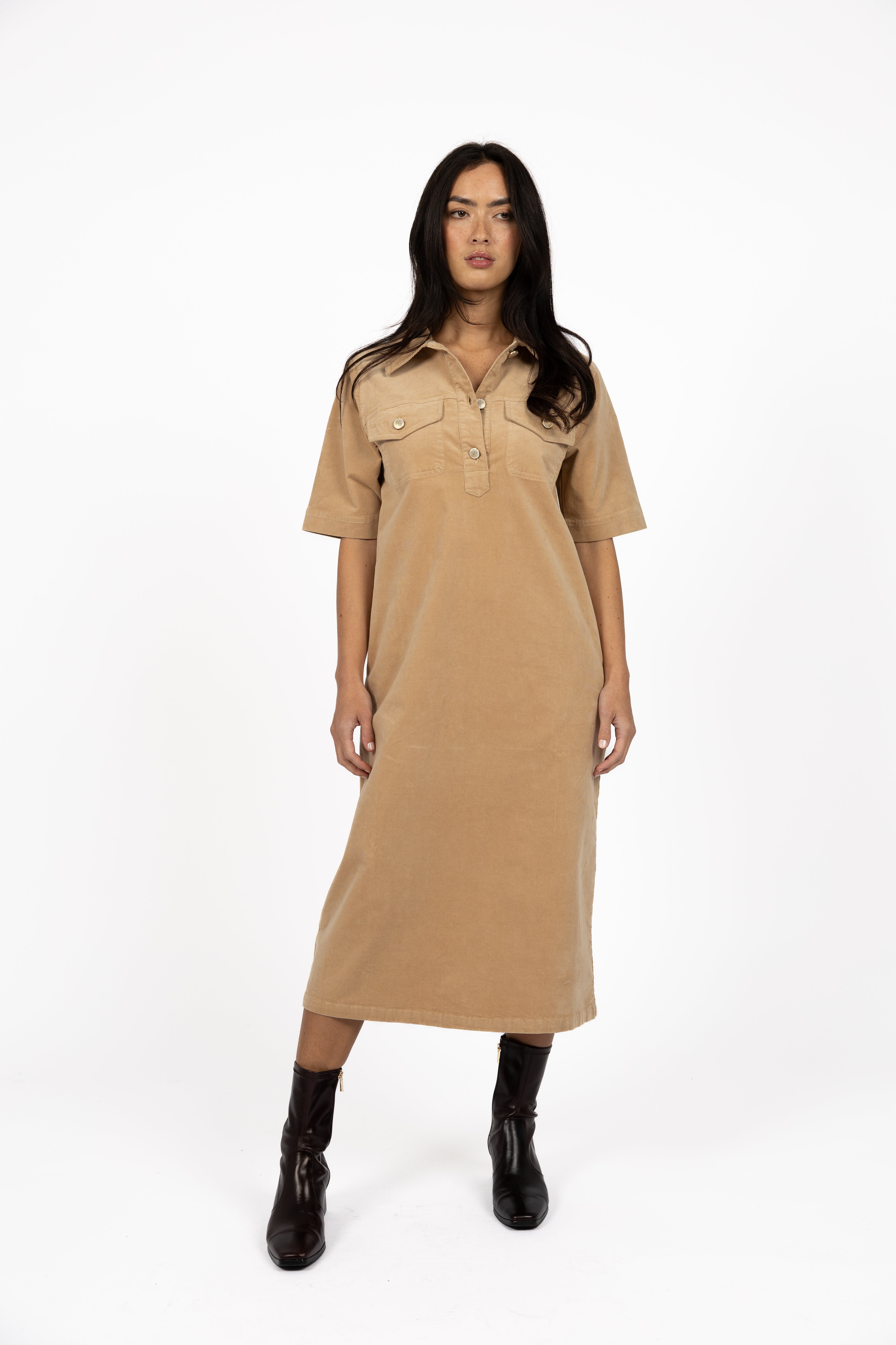 Image of Woman wearing Humidity Amici cord dress with black boots on a white background