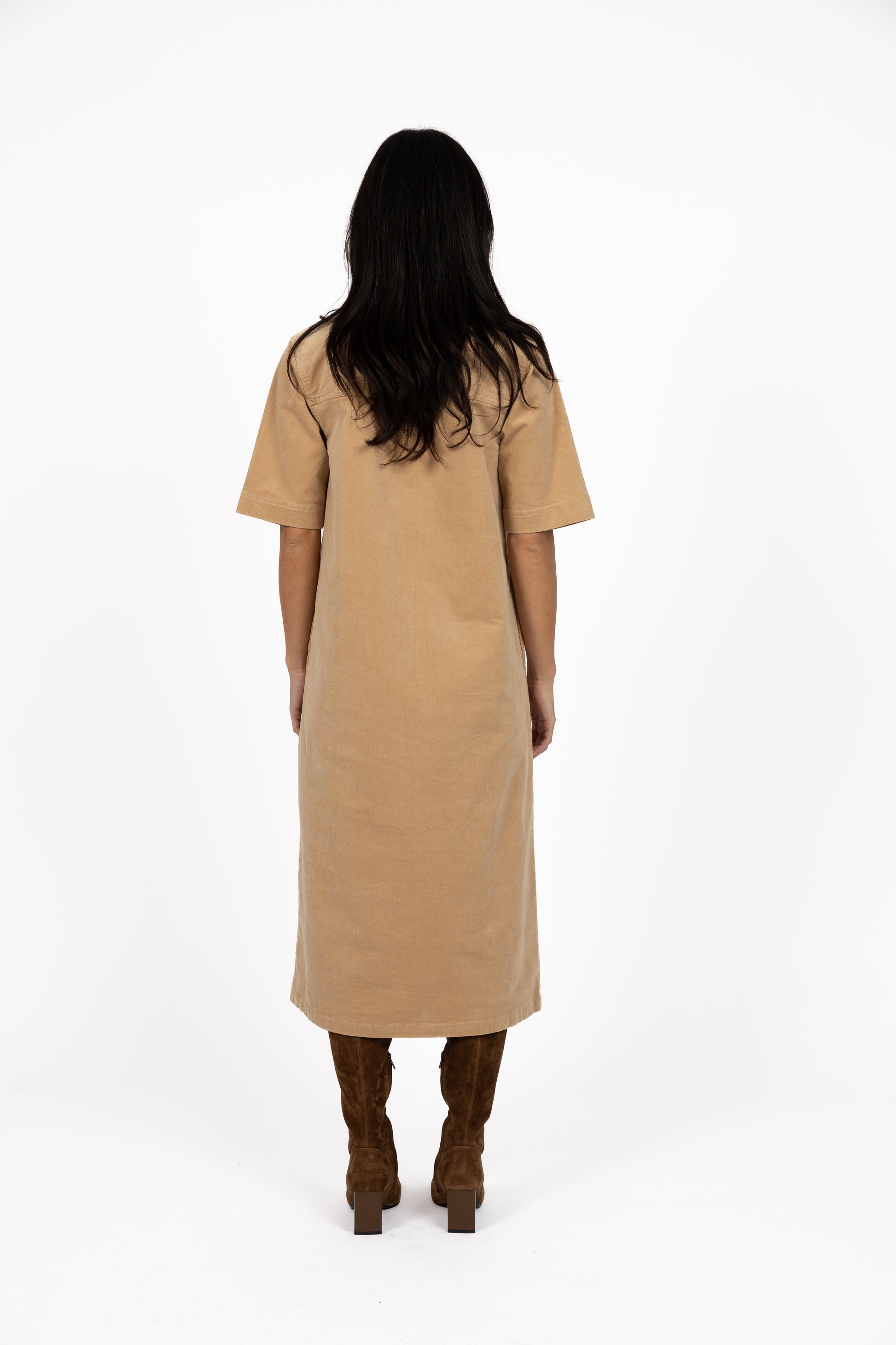 Woman wearing a Humidity beige dress on a white background