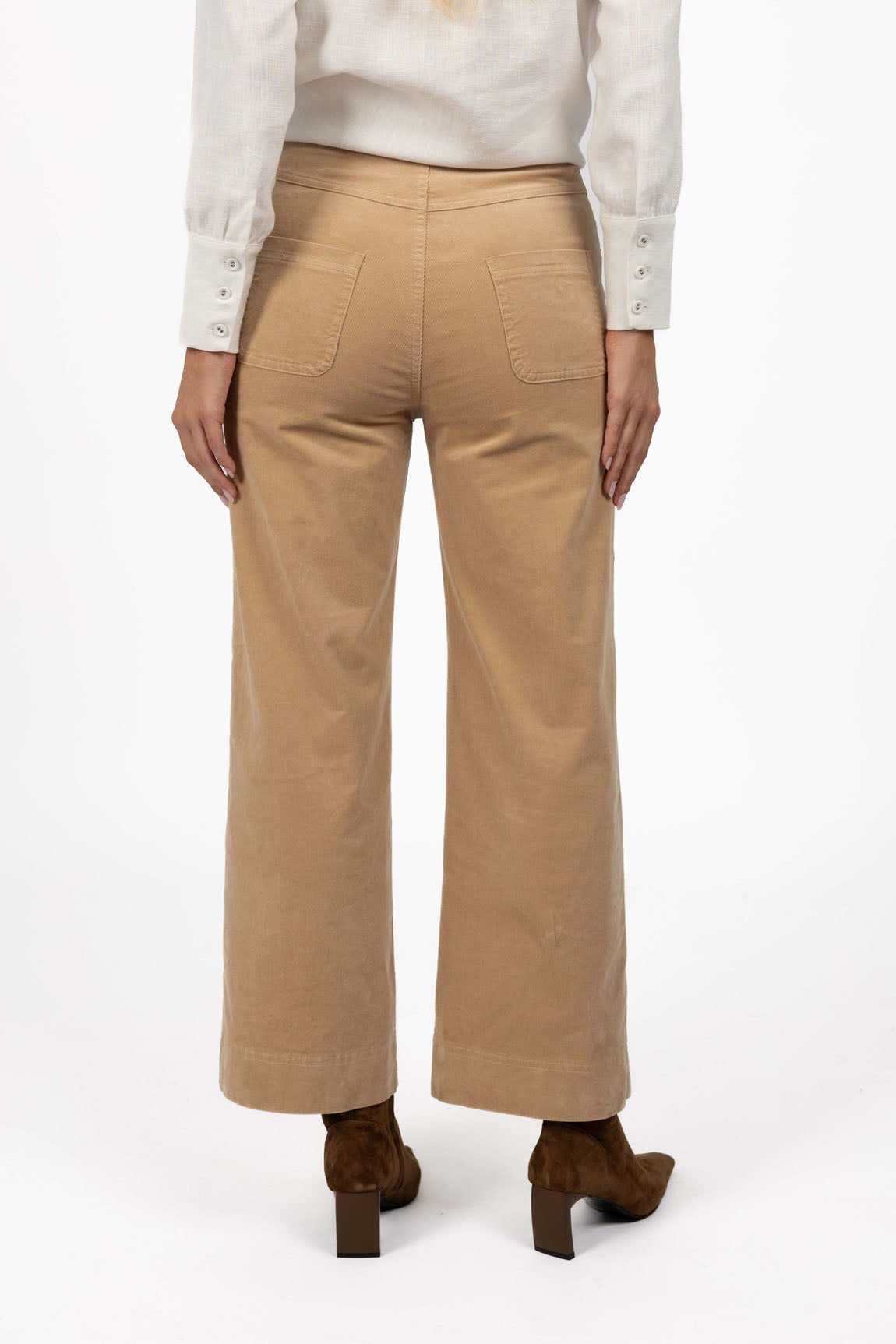 Humidity Beige pants worn by a woman on a white background