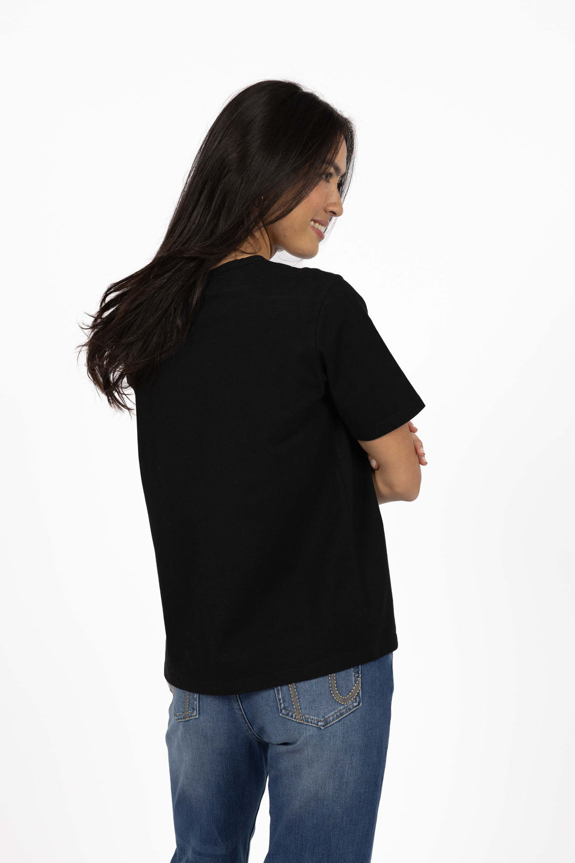 Image of Woman wearing a Humidity black t-shirt and blue jeans on a white background