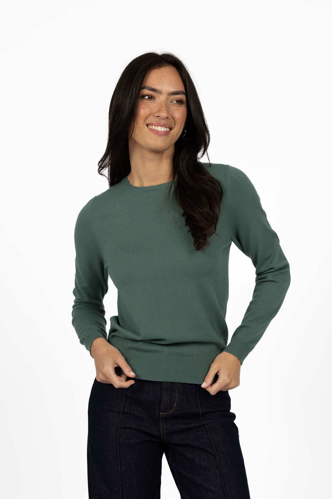 Woman wearing a Humidity green sweater on a white background