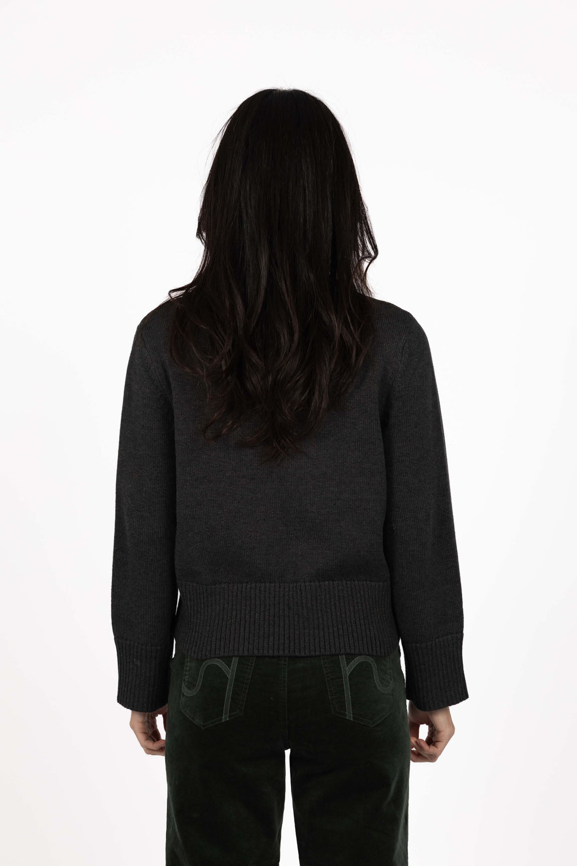 Image of Woman wearing a Humidity black sweater and pants on a white background