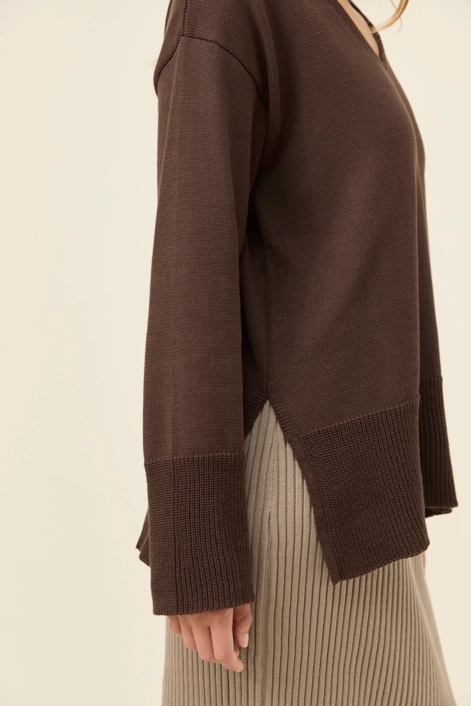 Image of Isle of Mine Brown sweater worn by a woman on a beige background