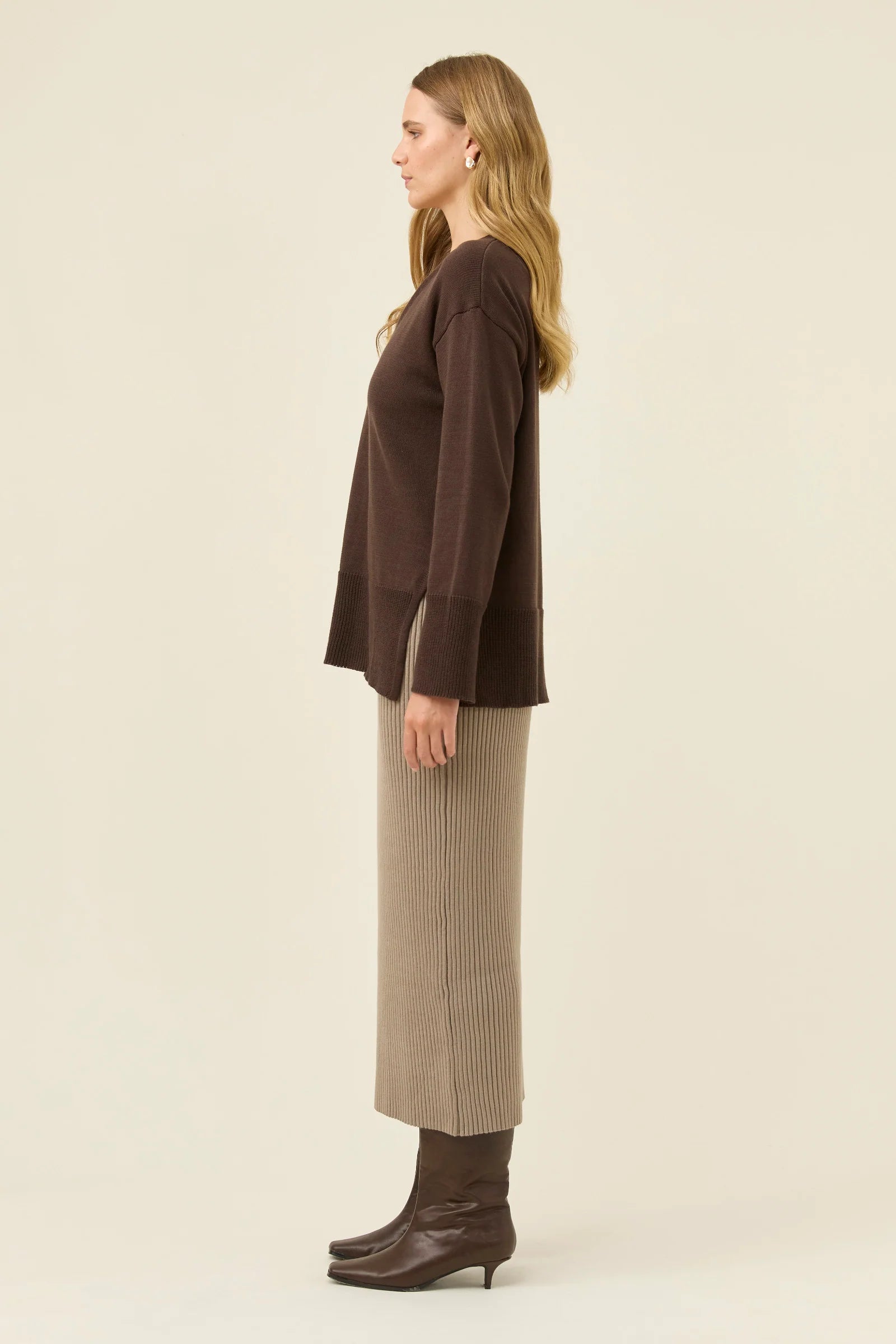 Image of Woman wearing a Isle of Mine brown top and beige skirt on a white background