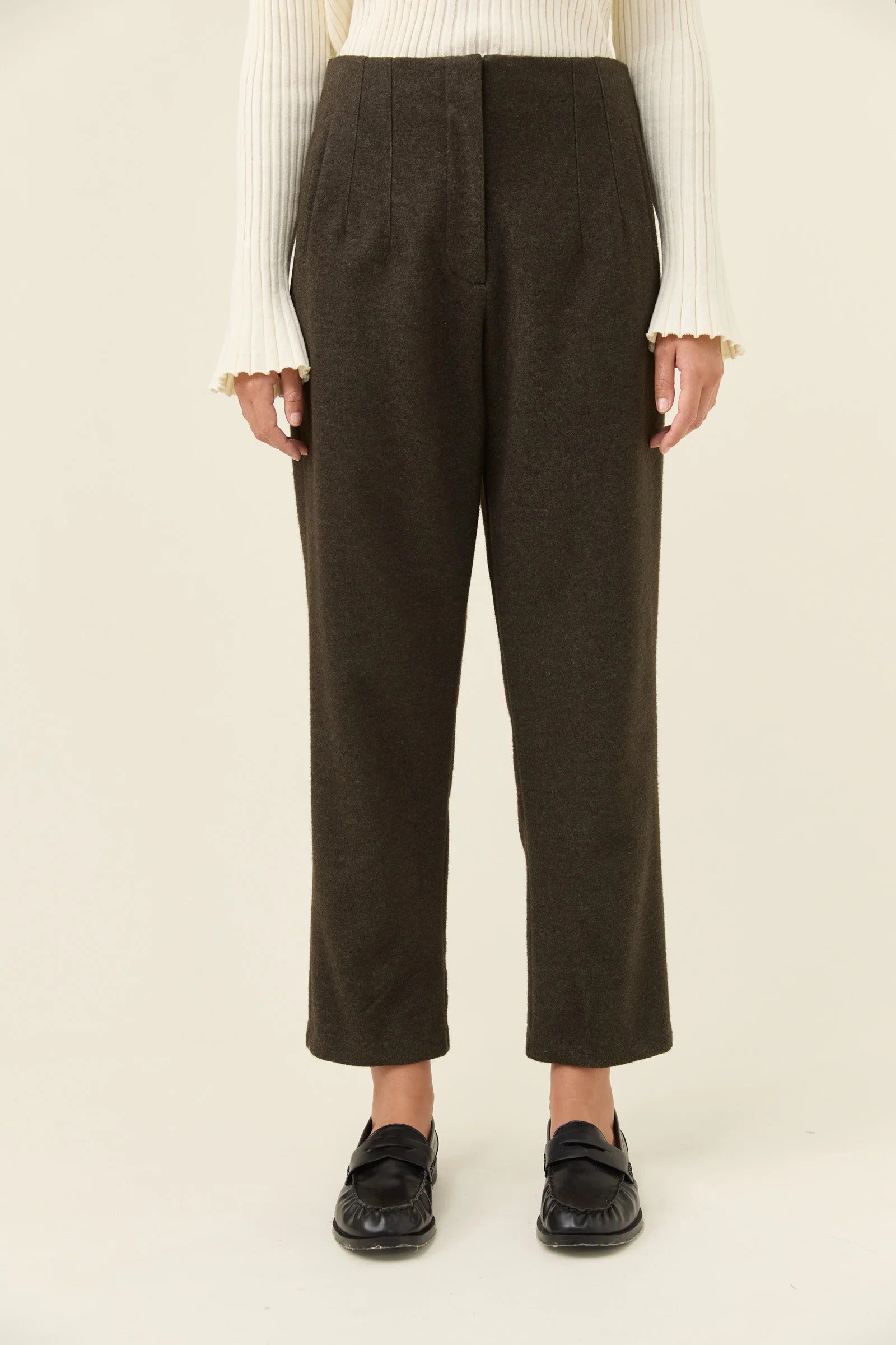 Person wearing Isle of Mine dark gray pants on a white background