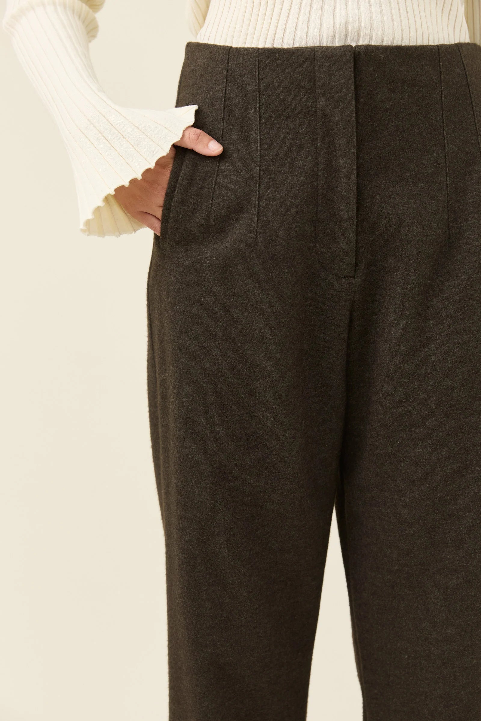 Image of Isle of Mine Brown pants worn by a woman on a light beige background
