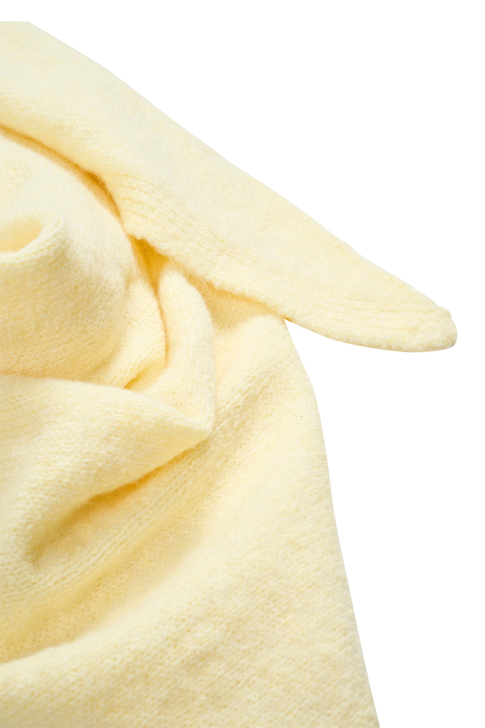Close-up of a Isle of Mine light yellow scarf texture on a white background