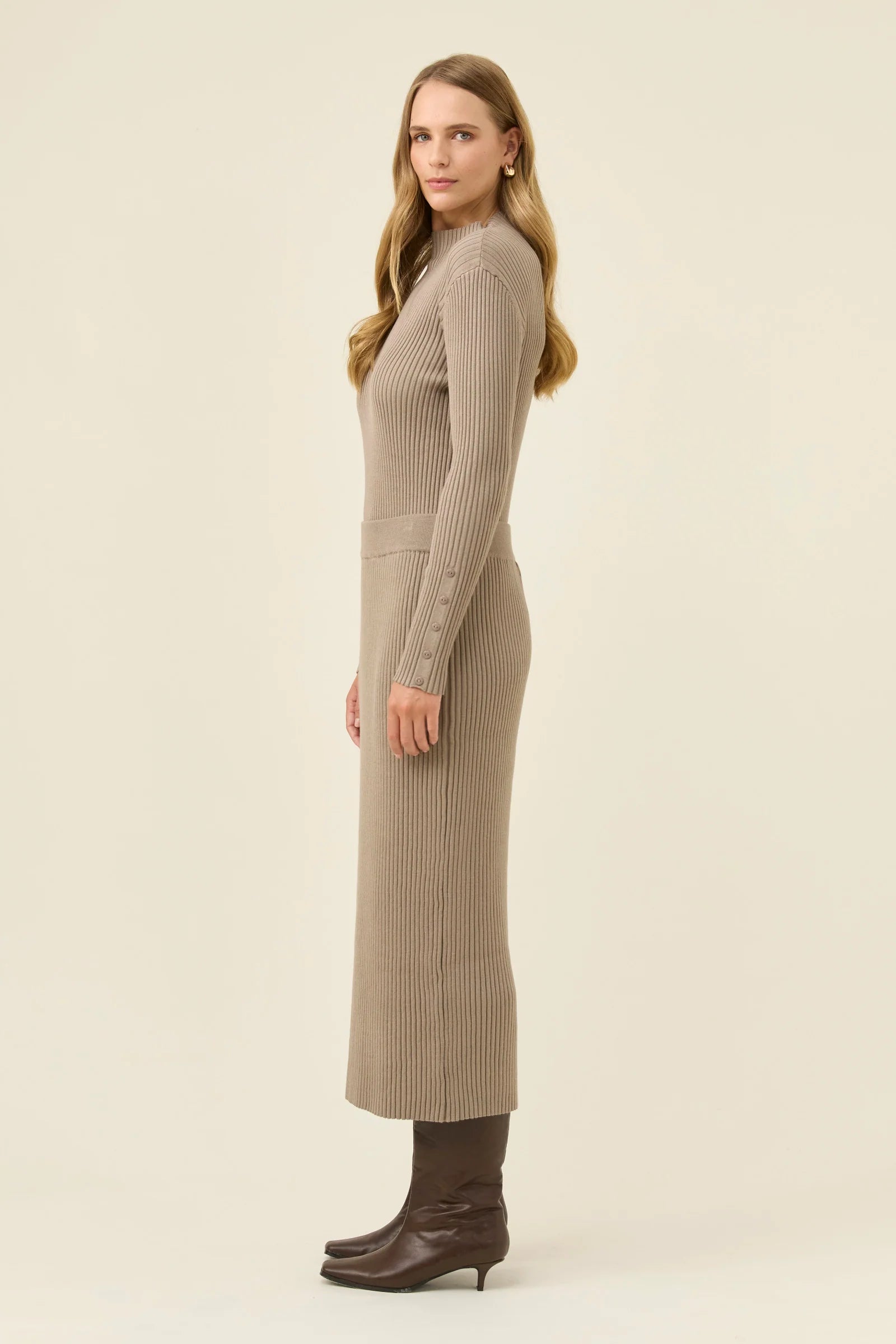 Woman wearing a Isle of Mine long beige ribbed skirt on a beige background