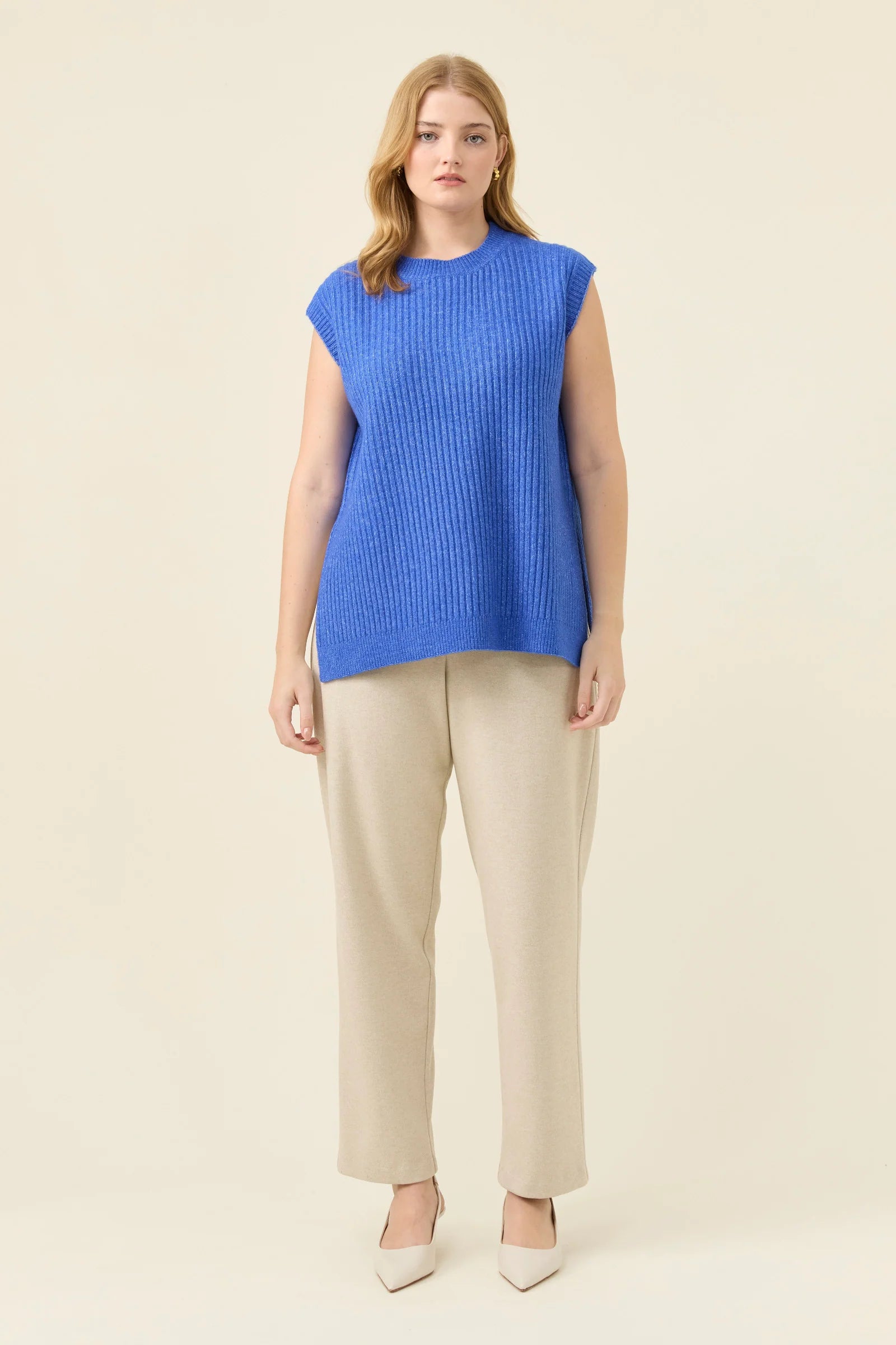 Image of Isle of Mine Blue ribbed knit sleeveless top worn by a woman on a beige background