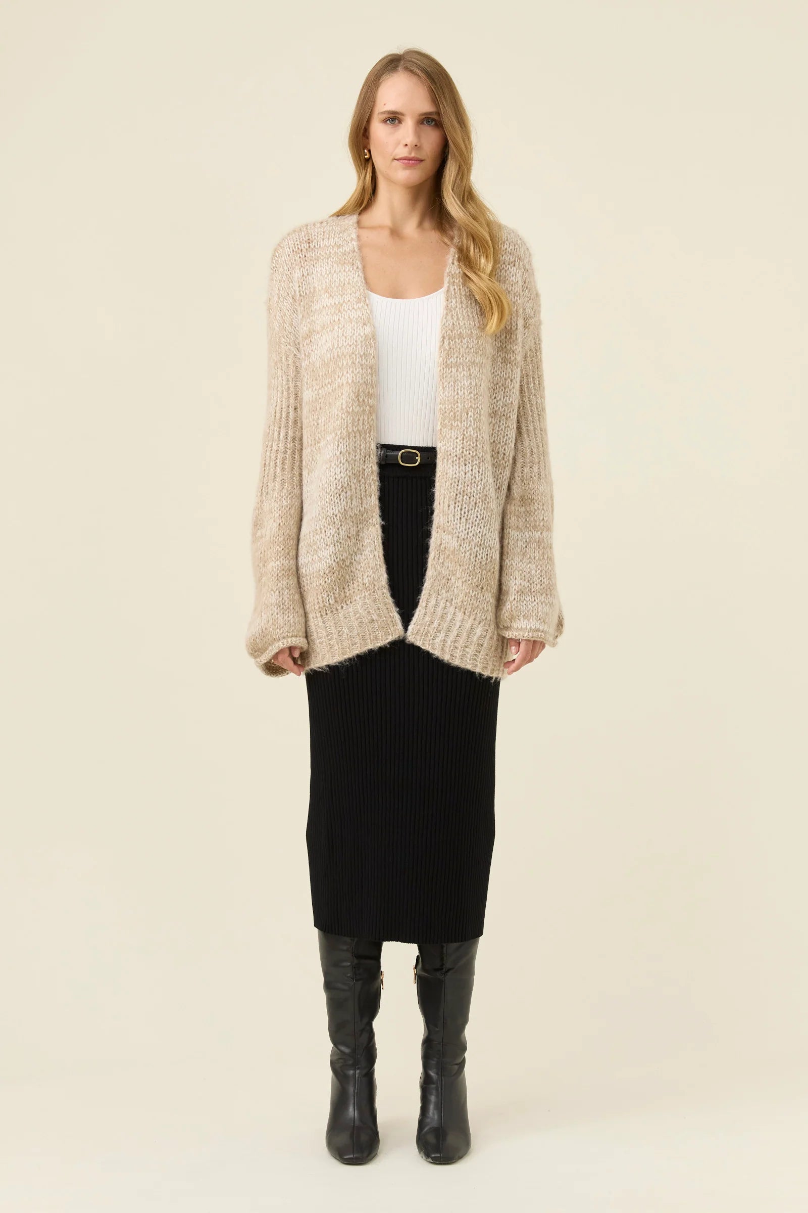 Image of Woman pictured wearing Isle of Mine relaxed cardigan paired with black skirt on a plain background
