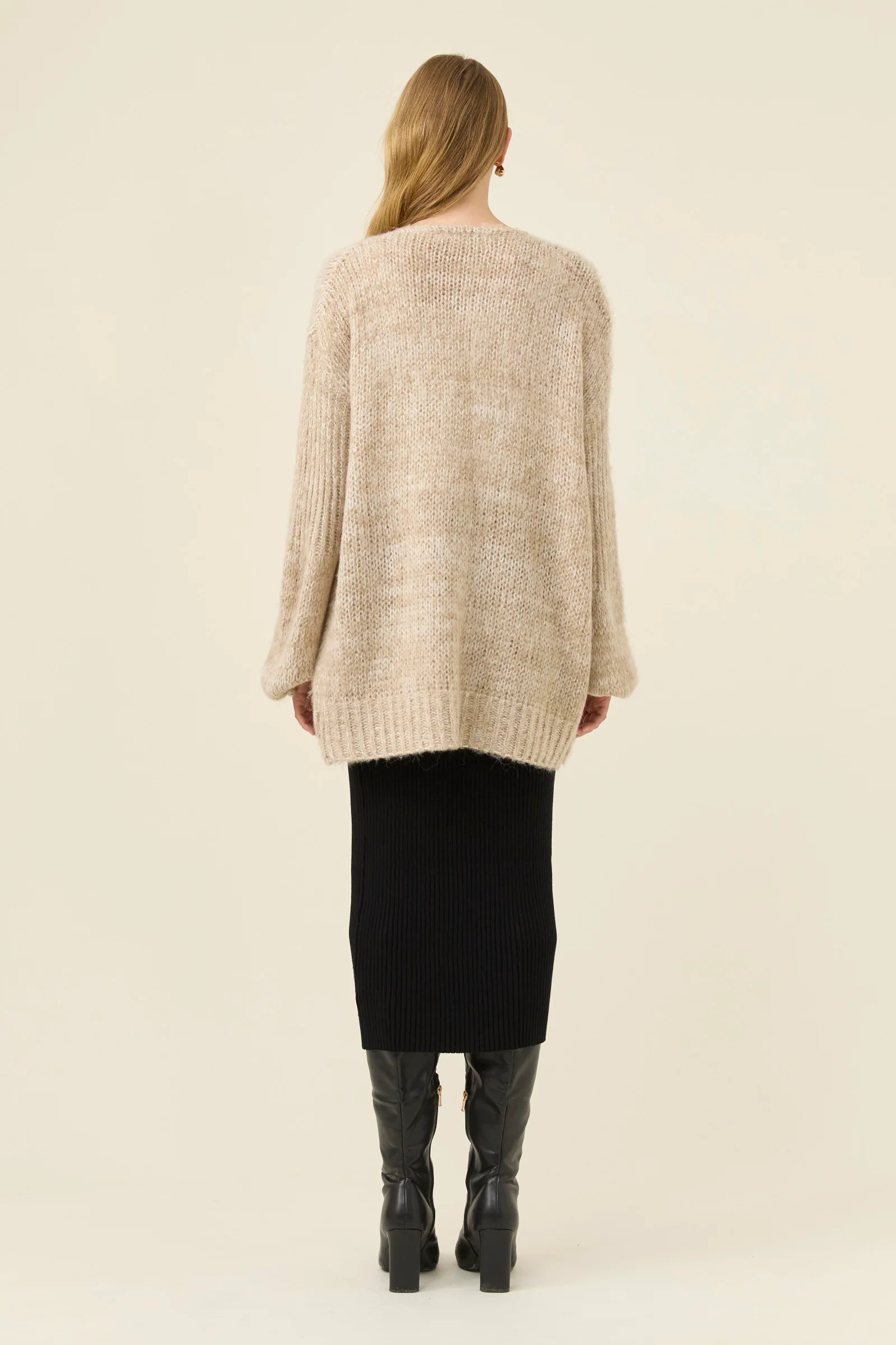 Image of Woman pictured wearing Isle of Mine relaxed cardigan paired with black skirt on a plain background