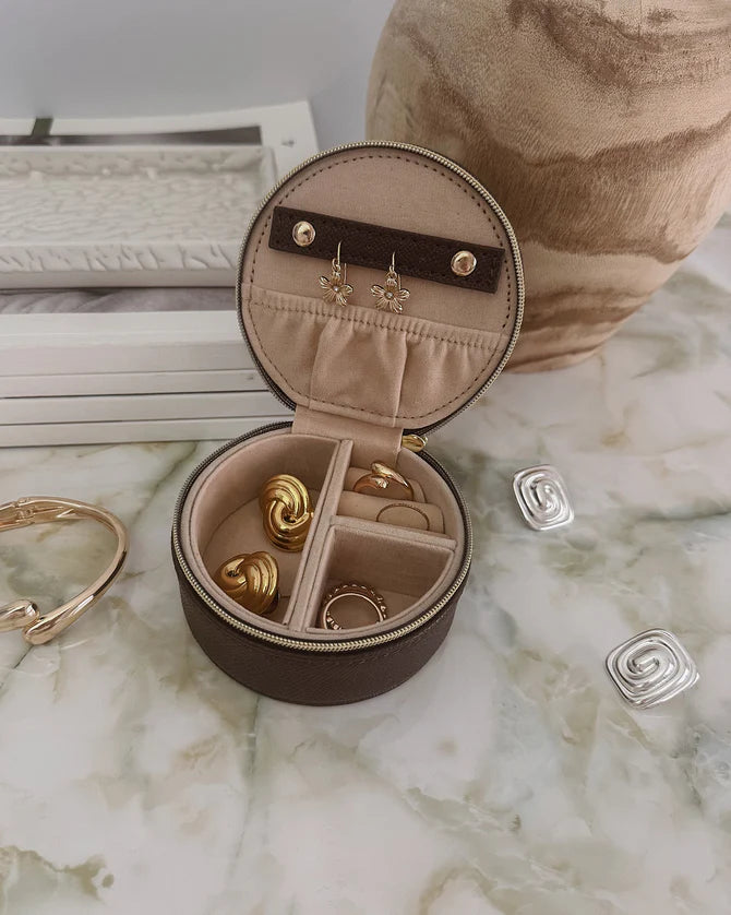 Collection of Louenhide Round brown jewelry box with jewelry on a marble surface in a gallery layout