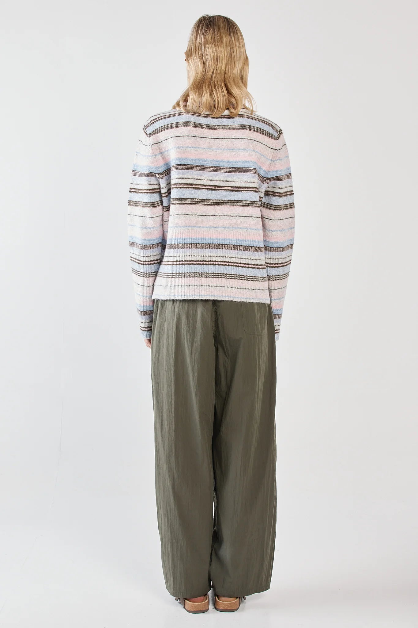 Image of Woman wearing a Sass striped sweater and wide-leg pants on a white background
