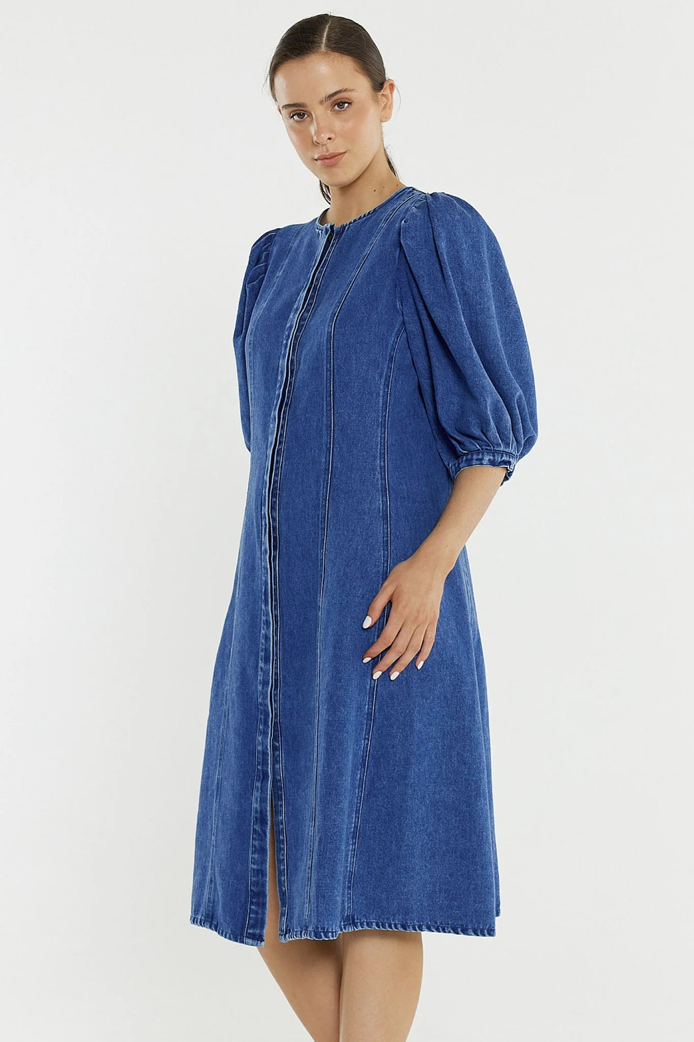 Image of Woman wearing a Sass blue denim dress on a white background