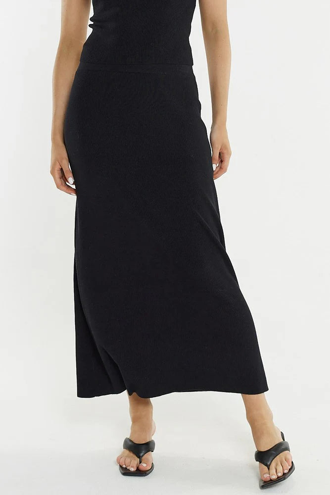 Woman wearing a Sass black skirt on a white background
