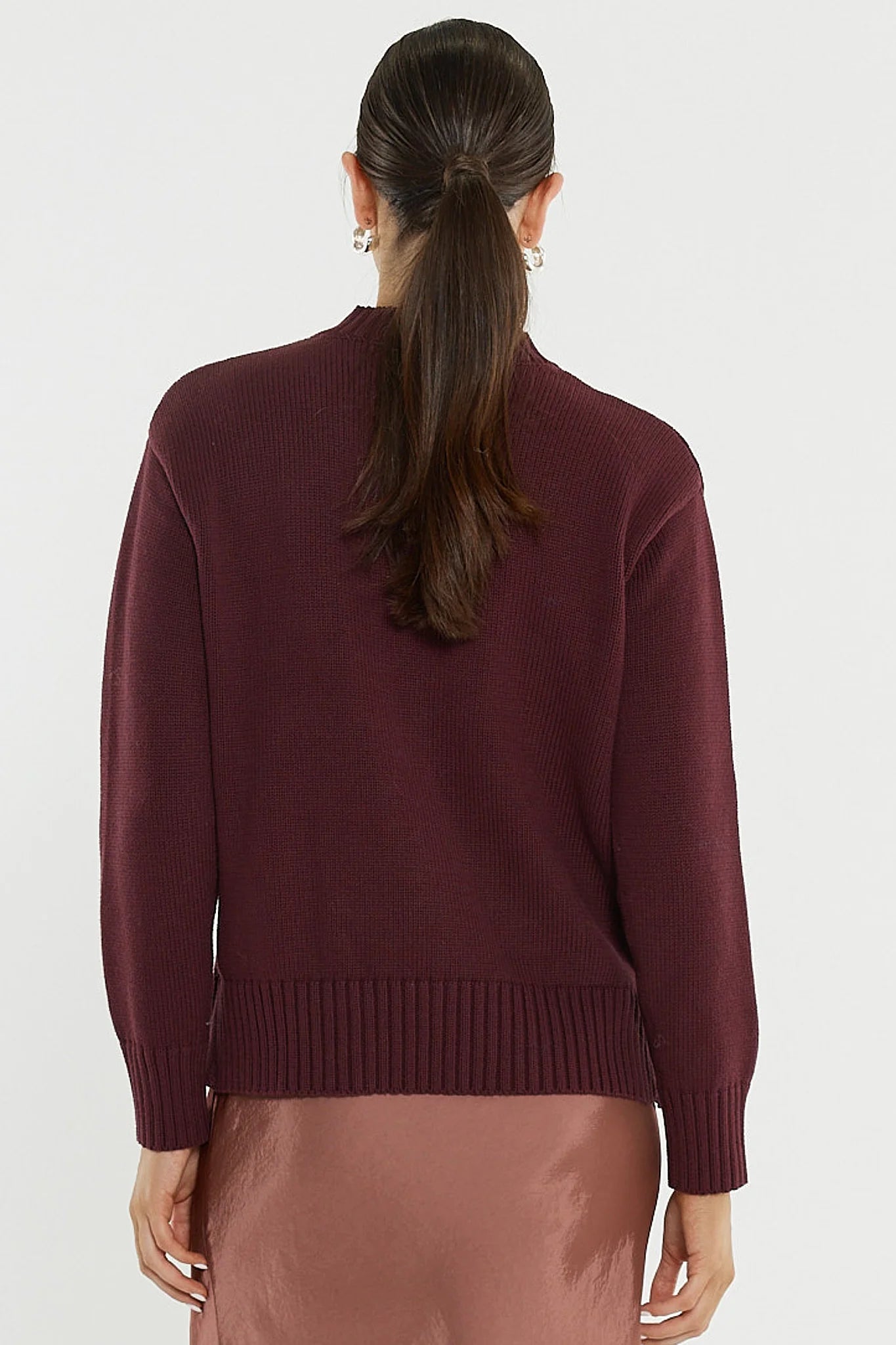 Image of Woman wearing a Sass burgundy sweater on a white background