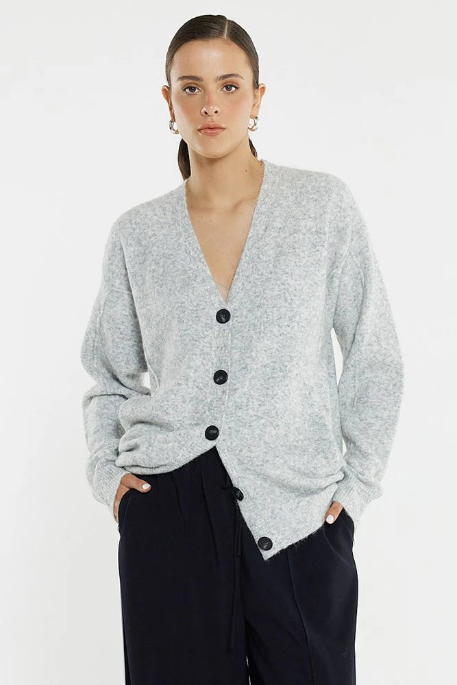 Image of Woman wearing a Sass gray cardigan with black buttons on a white background