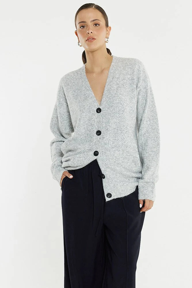 Image of Woman wearing a Sass grey cardigan with black buttons on a white background