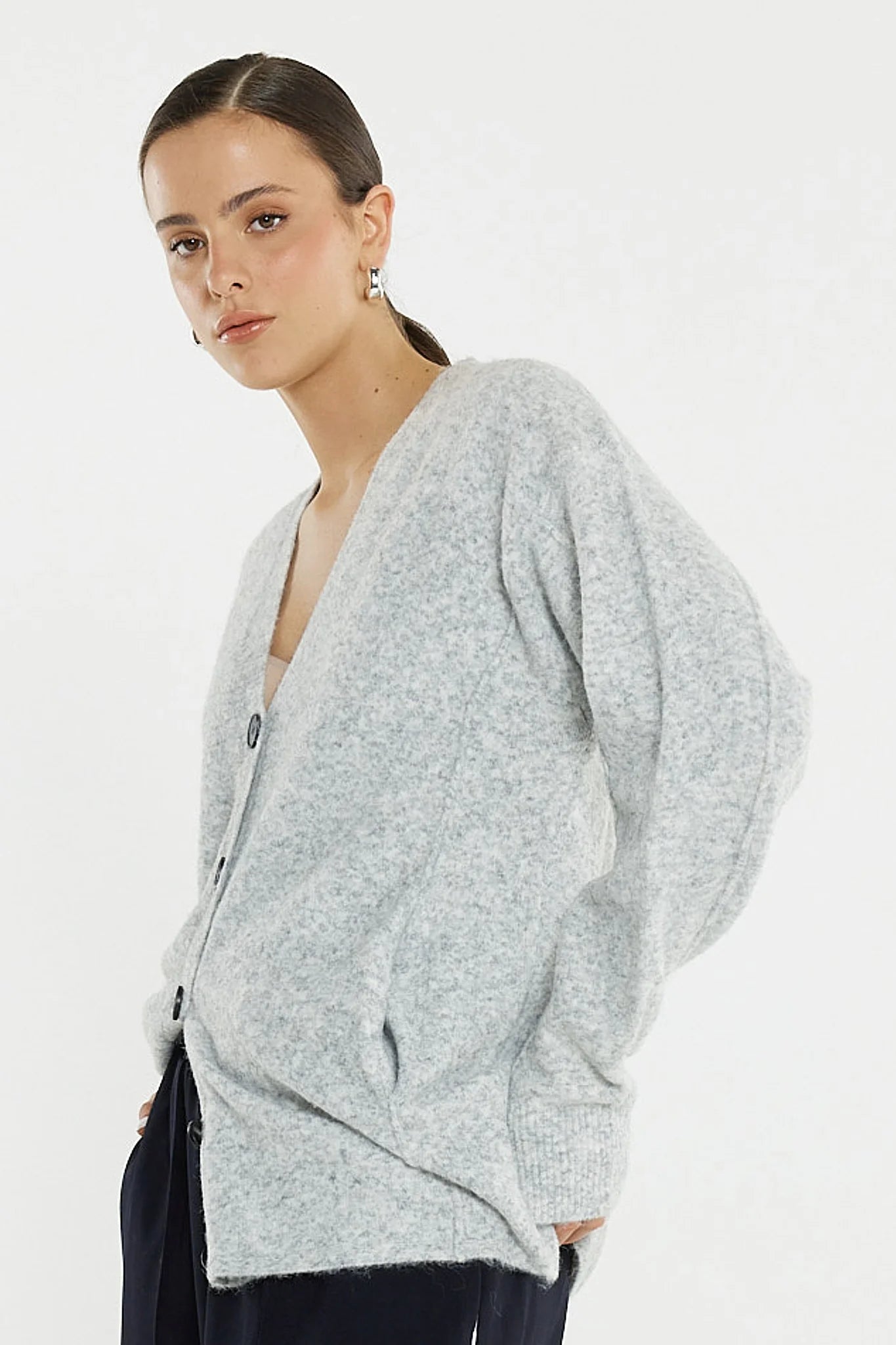 Image of Woman wearing a Sass light grey cardigan on a white background