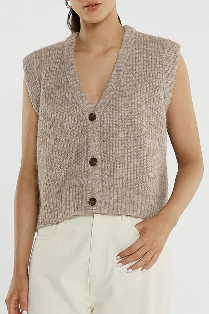 Image of Woman wearing a Sass brown knitted vest with buttons on a white background