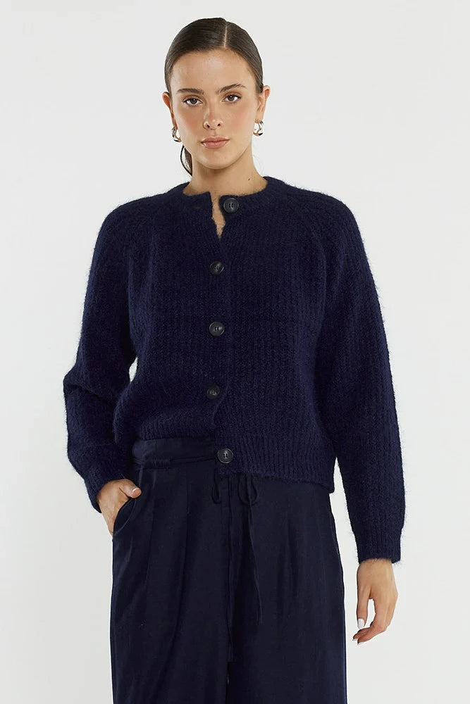 Image of Woman wearing a Sass dark blue cardigan and pants on a white background