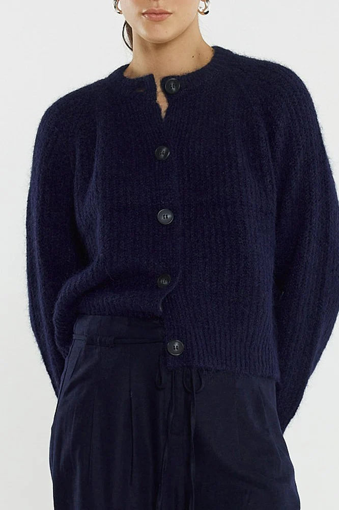Image of Woman wearing a Sass dark blue cardigan on a white background