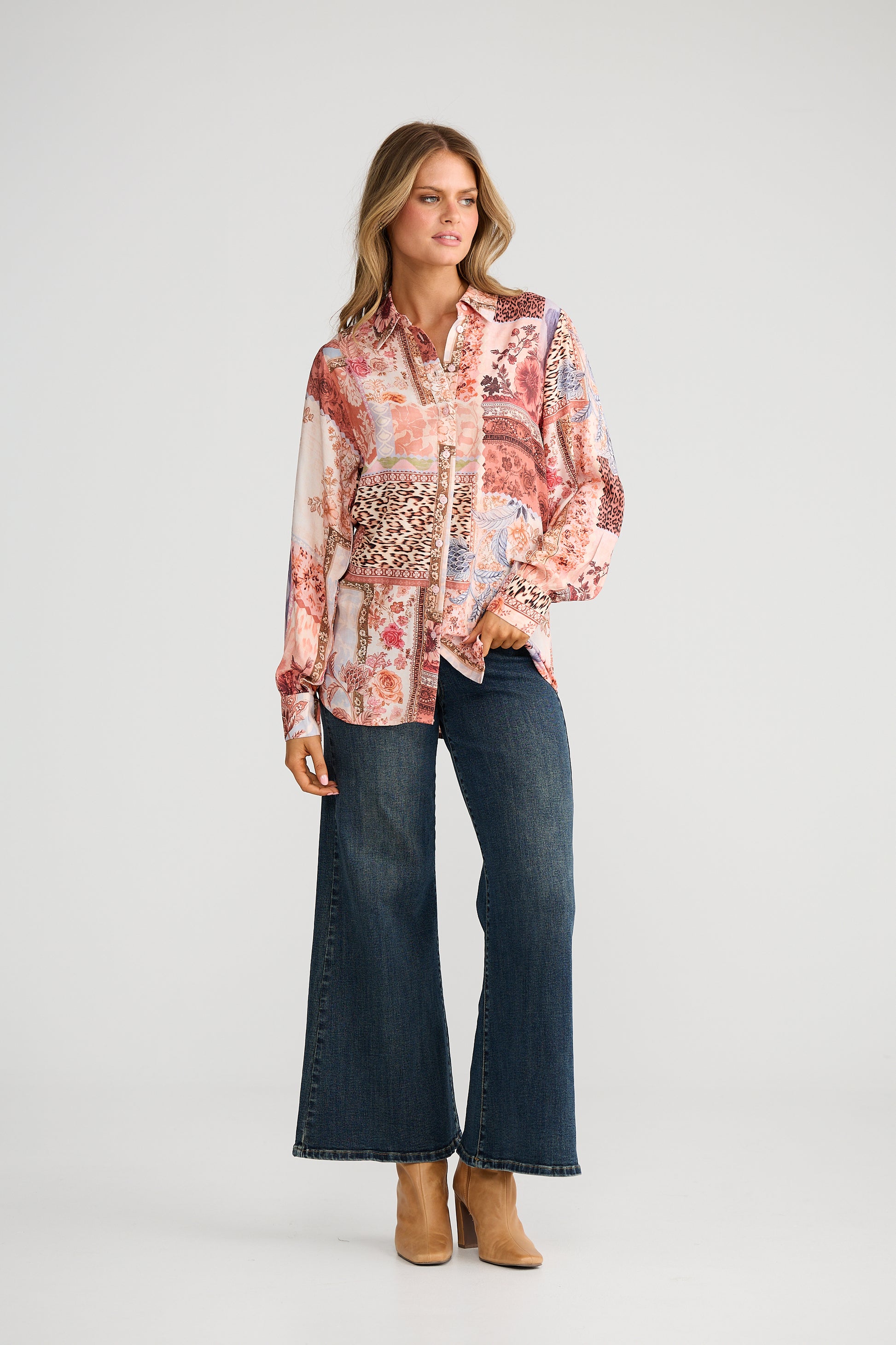 Woman wearing a Talisman patterned blouse with a neutral background