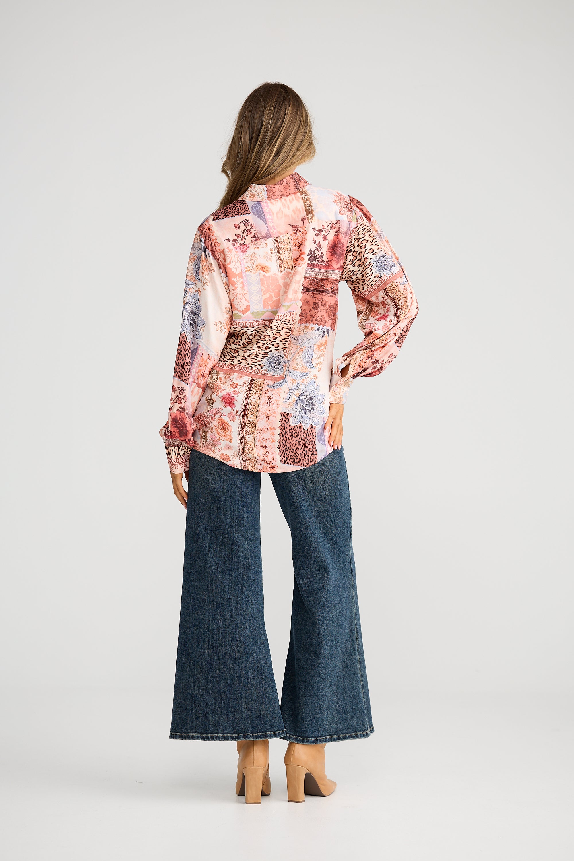 Collection of Woman wearing a Talisman patterned blouse with a neutral background in a gallery layout
