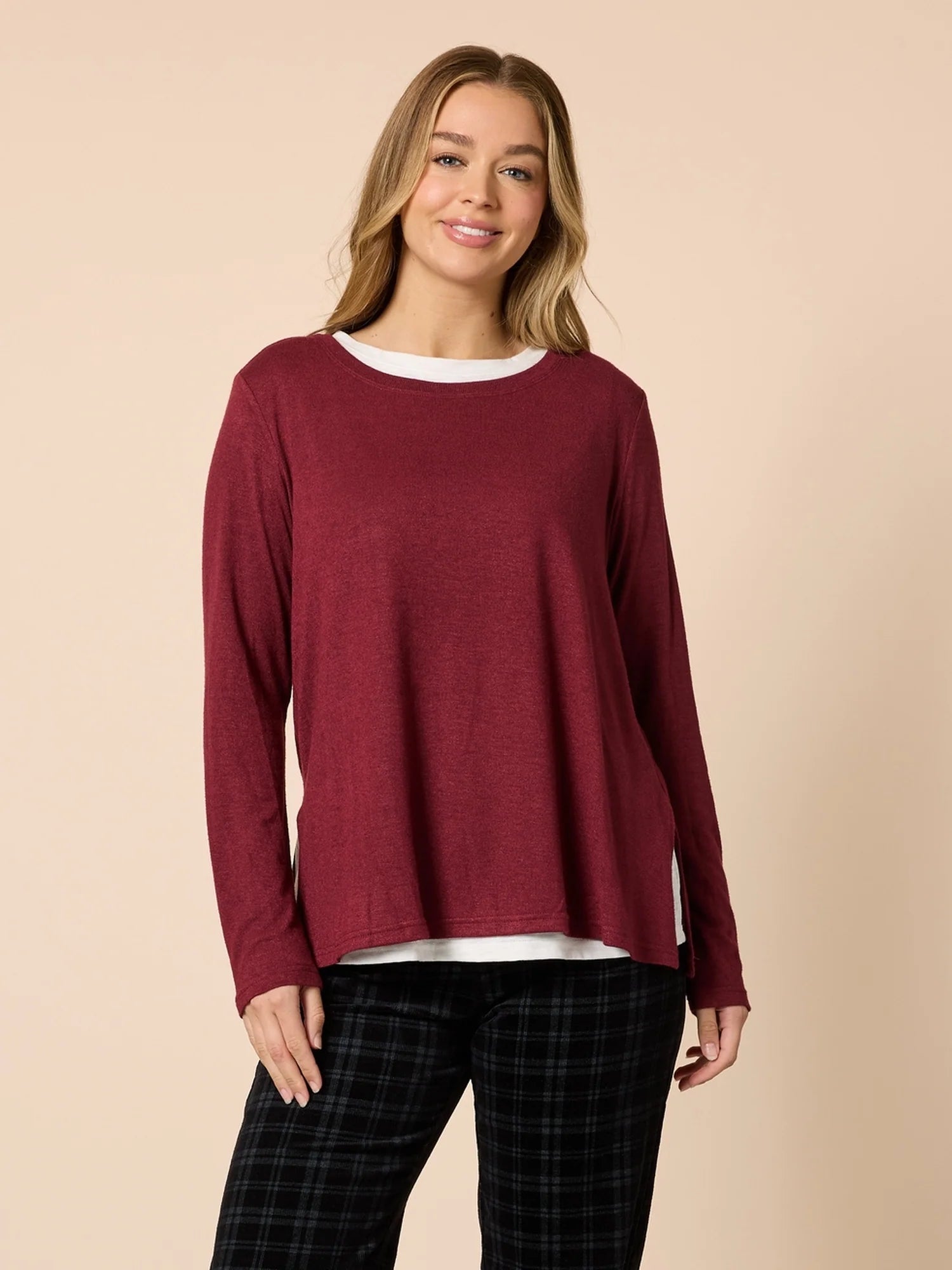 Image of Woman wearing a Threadz burgundy long-sleeve top against a beige background