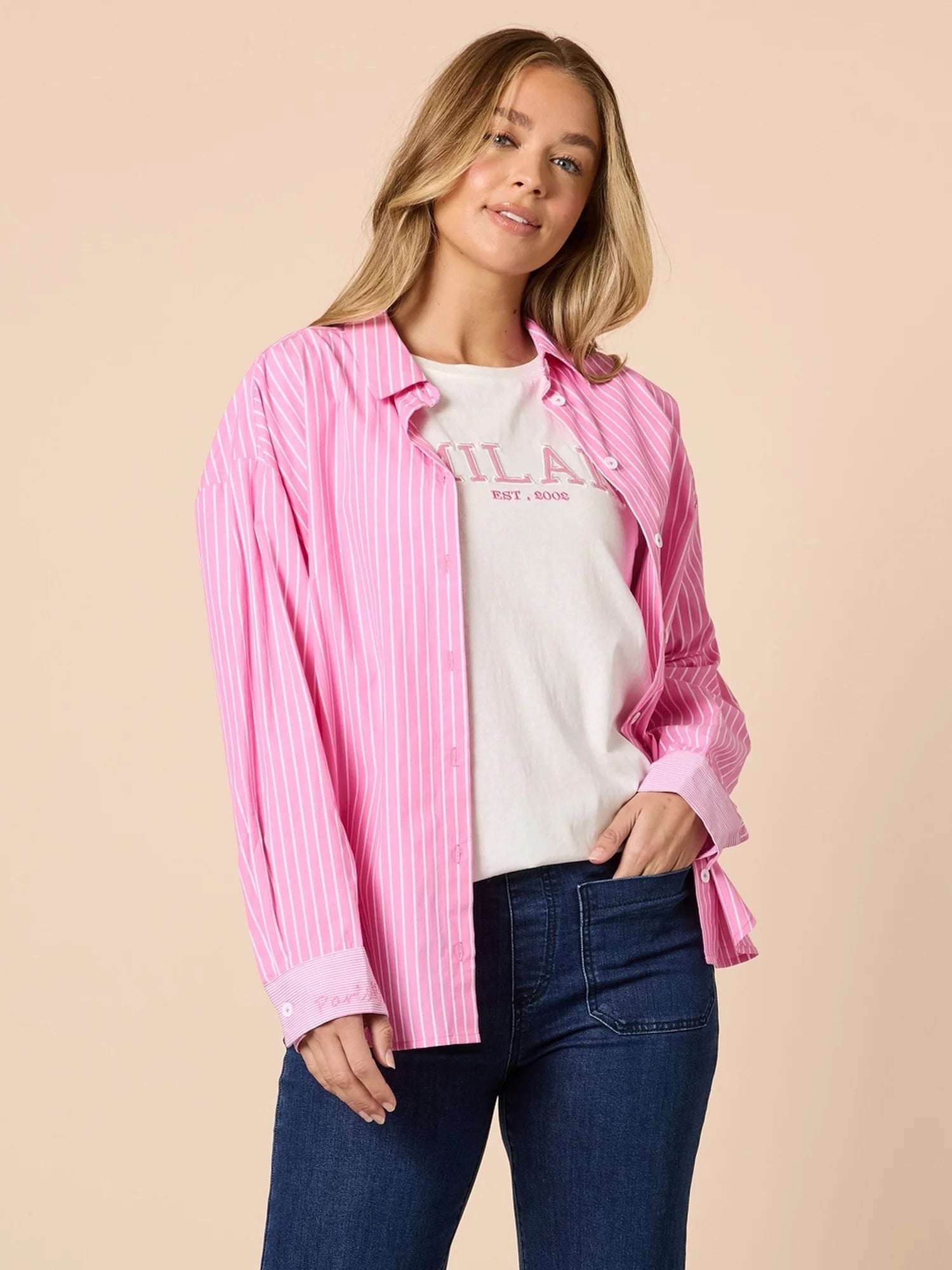 Collection of Woman wearing a Threadz pink striped shirt over a white t-shirt with text, standing against a beige background in a gallery layout