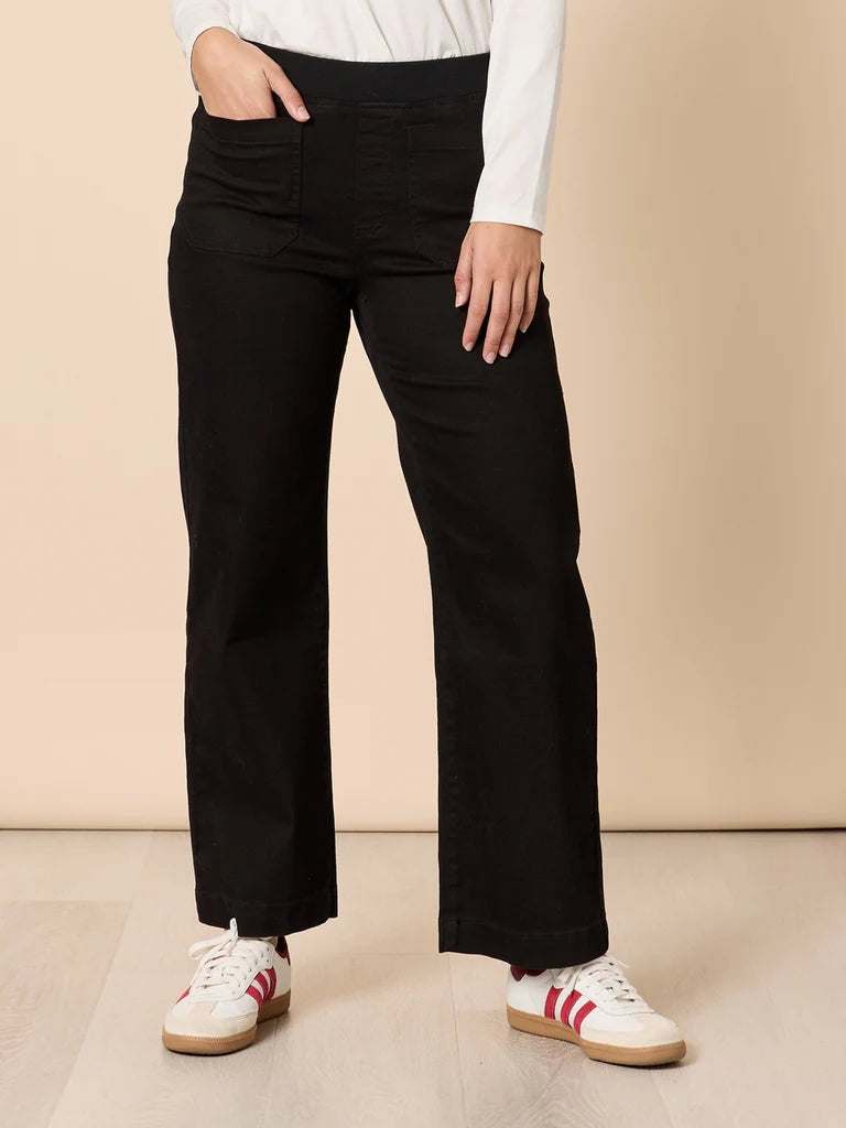 Image of Woman wearing Threadz black wide-leg pants with a beige background