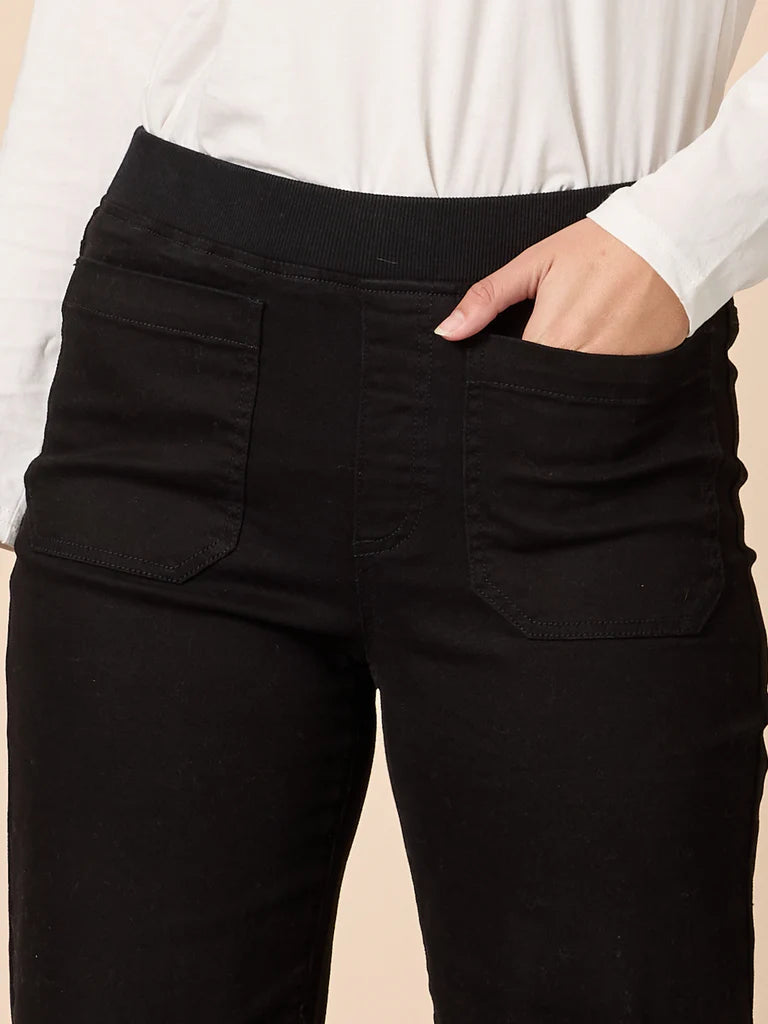 Threadz Black pants worn by a woman with a beige background