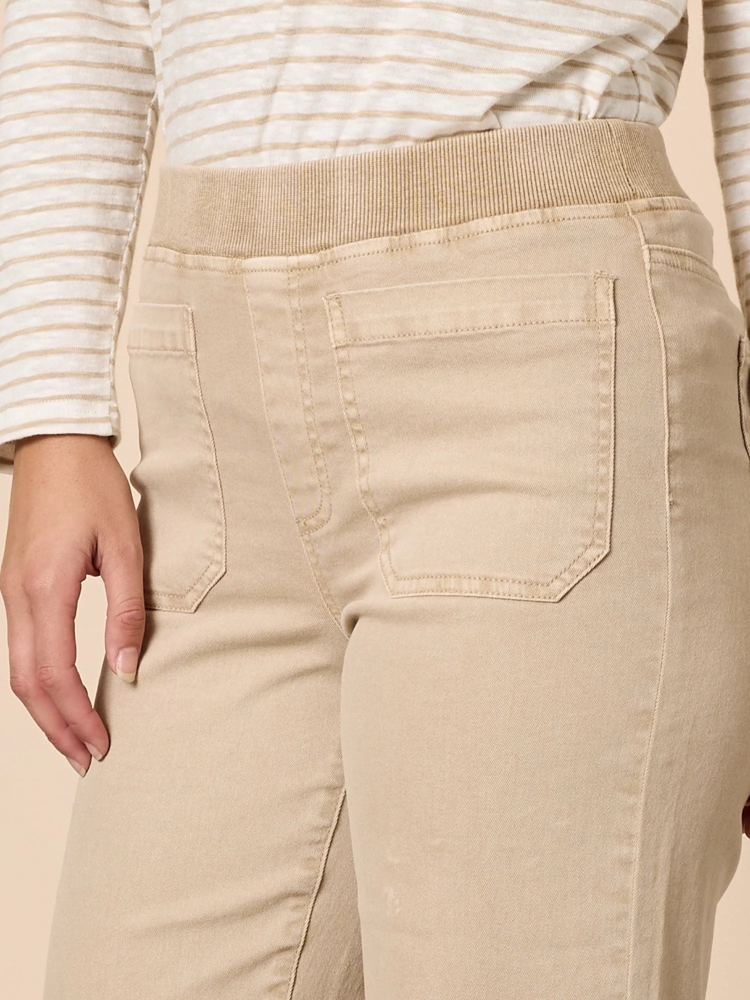 Image of Threadz Beige pants with a striped shirt worn by a woman on a beige background