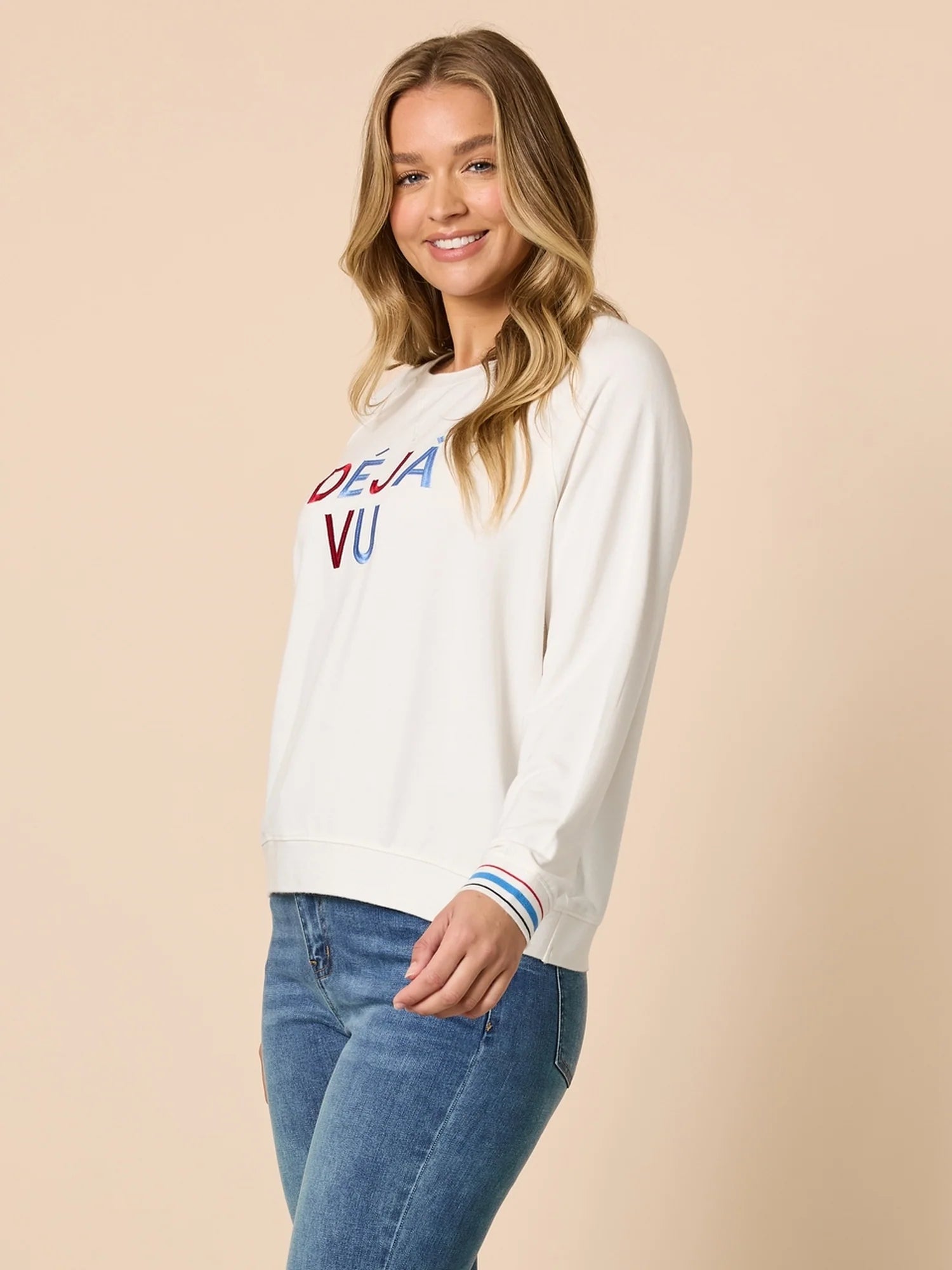 Collection of Woman wearing a Threadz white sweatshirt with colorful text on a beige background in a gallery layout
