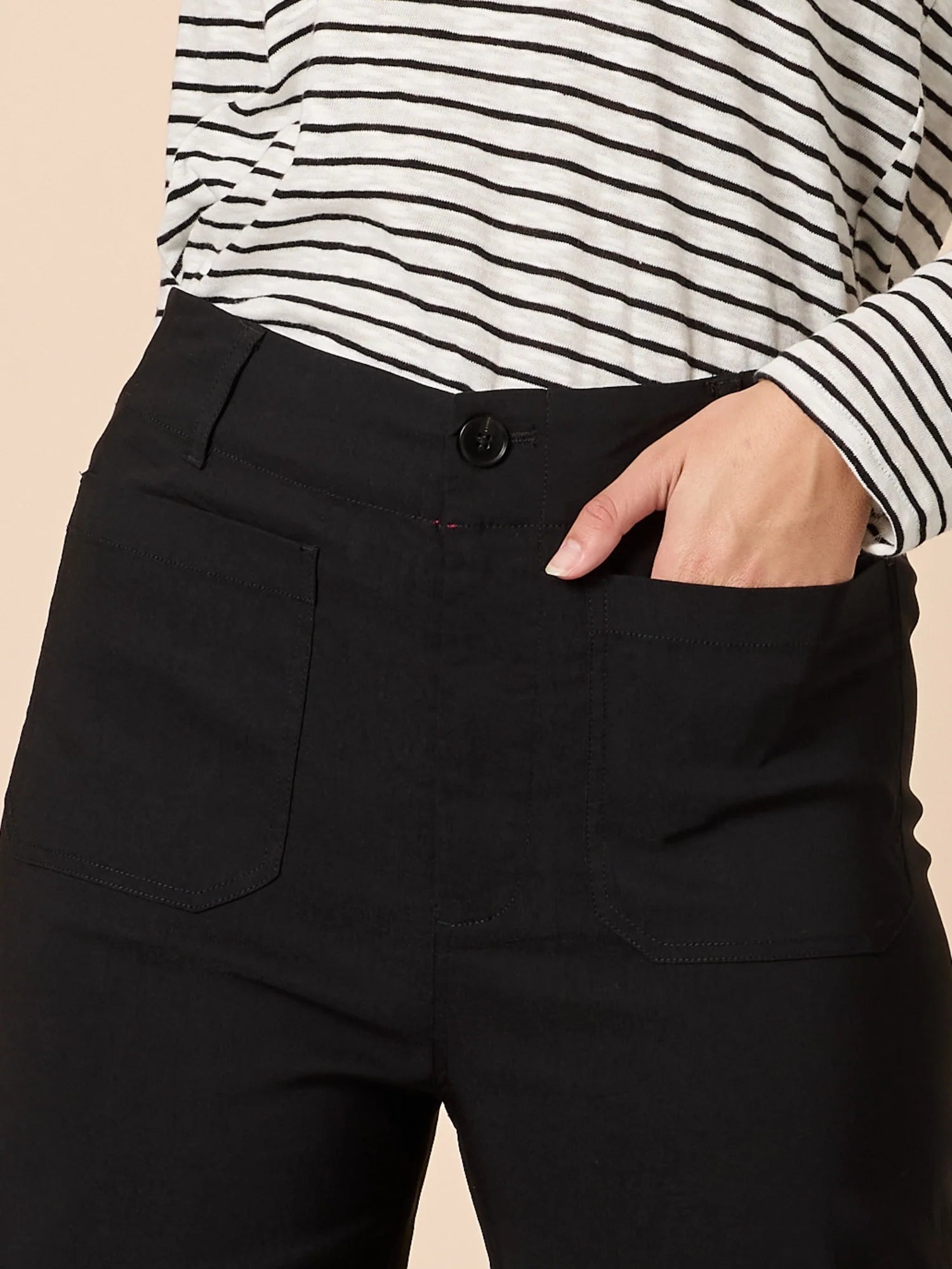 Image of Women wearing Threadz black wide-leg pants with a striped shirt and sneakers on a beige background