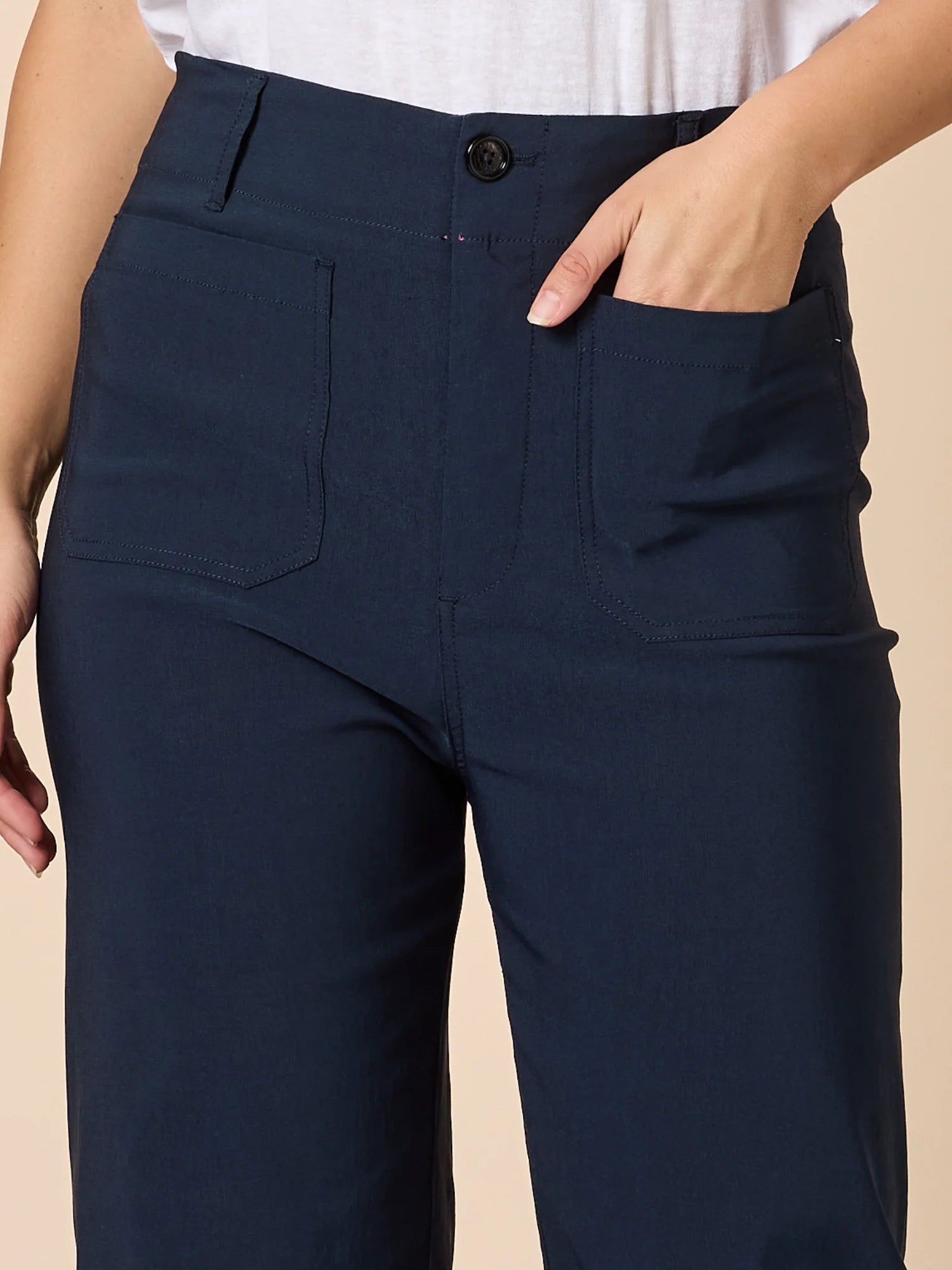 Image of Woman wearing a striped long-sleeve top and Threadz navy wide leg pants against a beige background