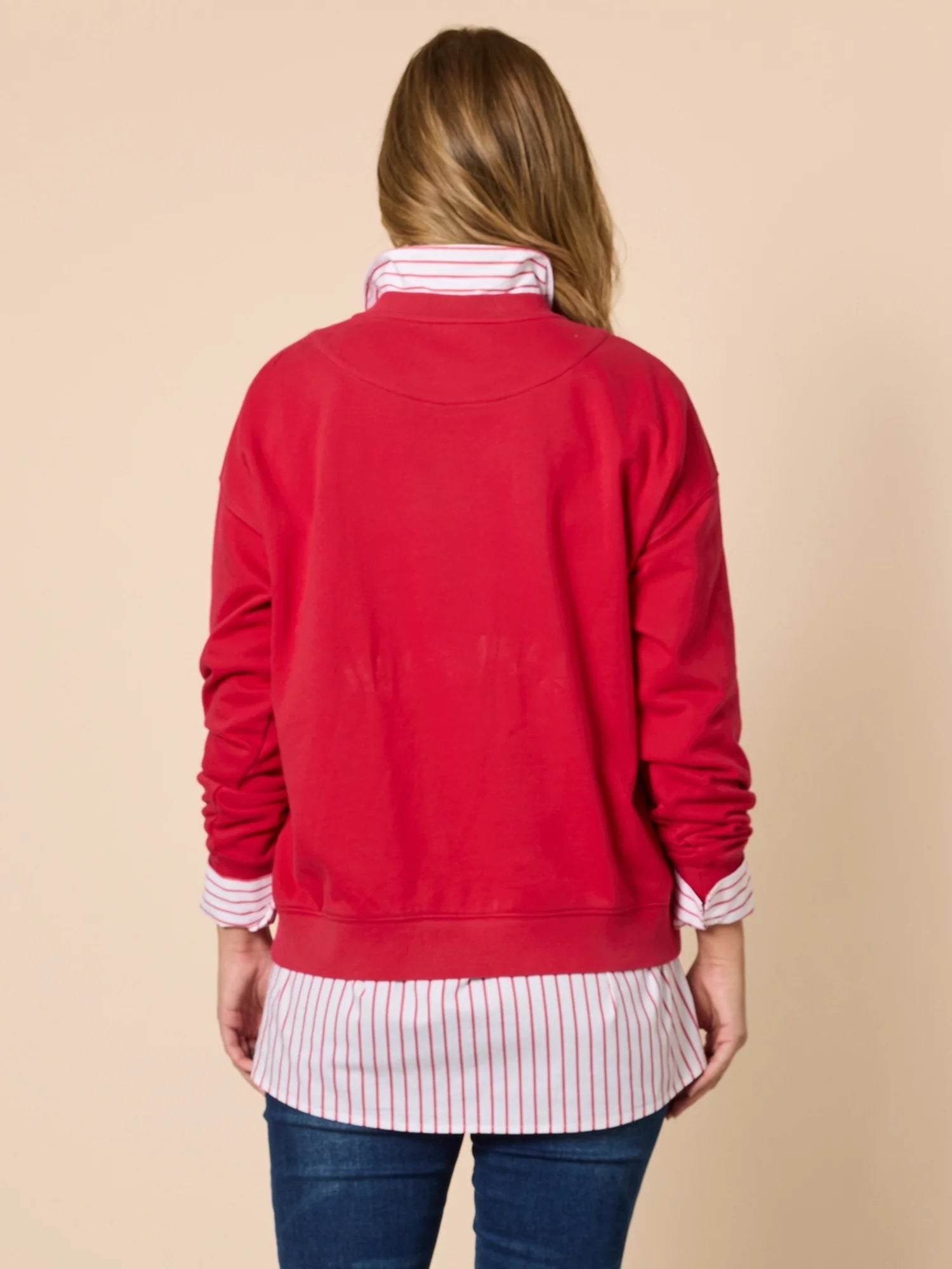 Collection of Person wearing a Threadz red sweater over a striped shirt with a beige background in a gallery layout