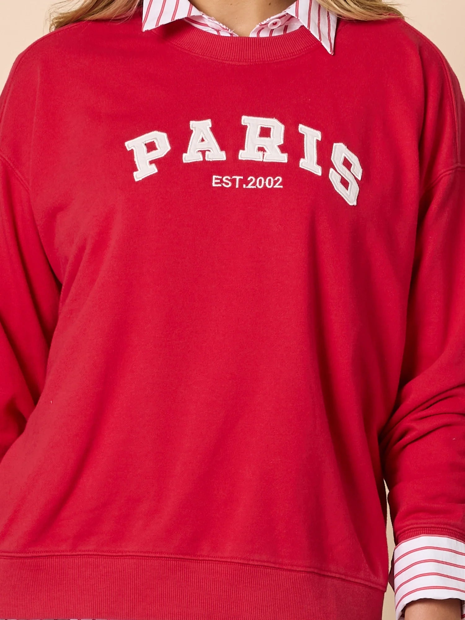 Collection of Threadz Red sweatshirt with 'PARIS EST. 2002' text worn by a person. in a gallery layout