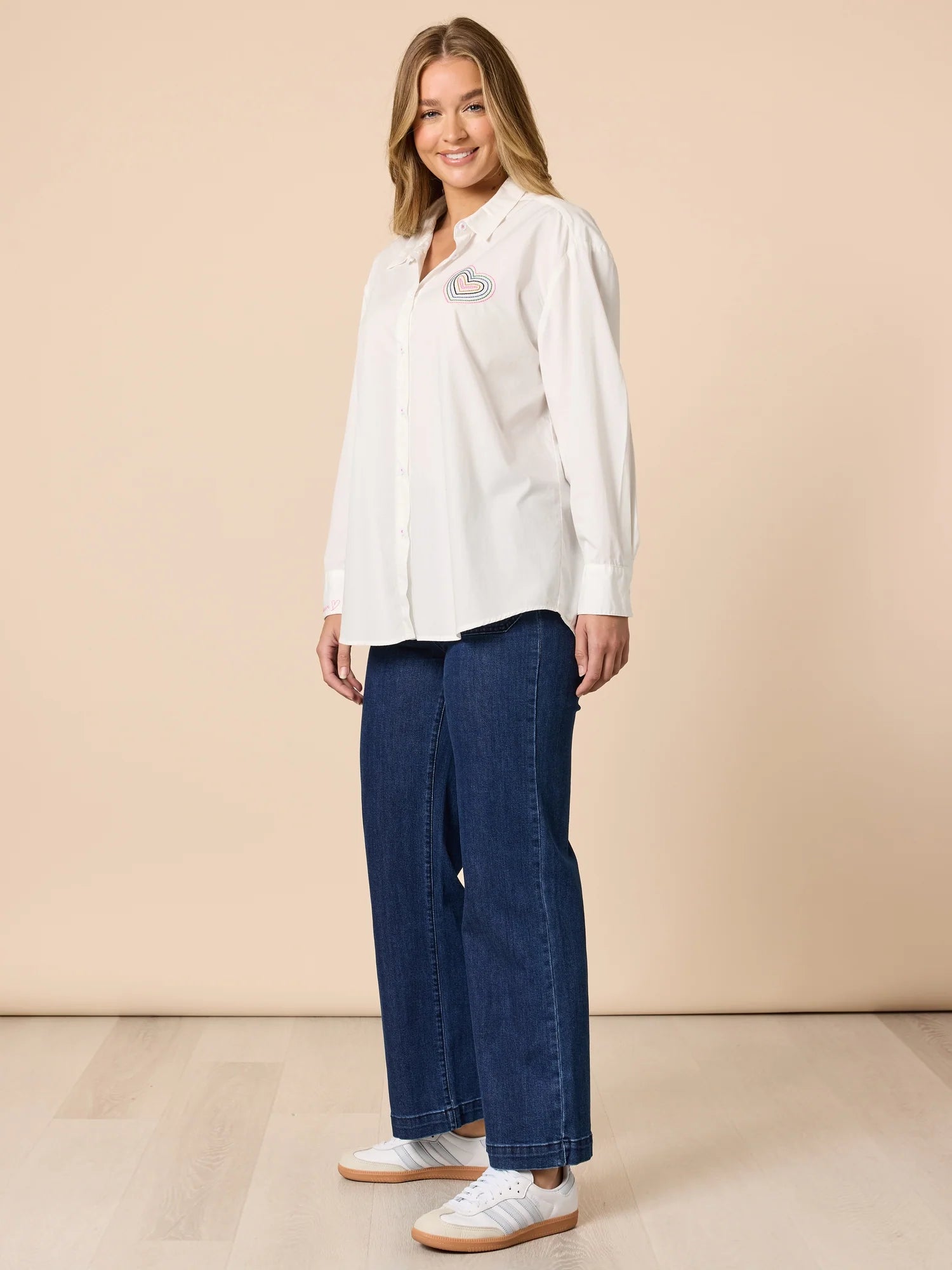 Collection of Woman wearing Threadz white shirt with denim jeans in a gallery layout