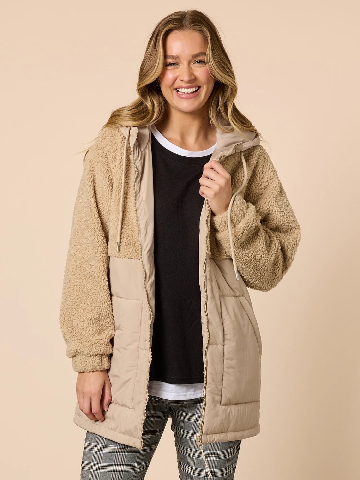 Image of Woman wearing a Threadz beige quilted jacket on a beige background