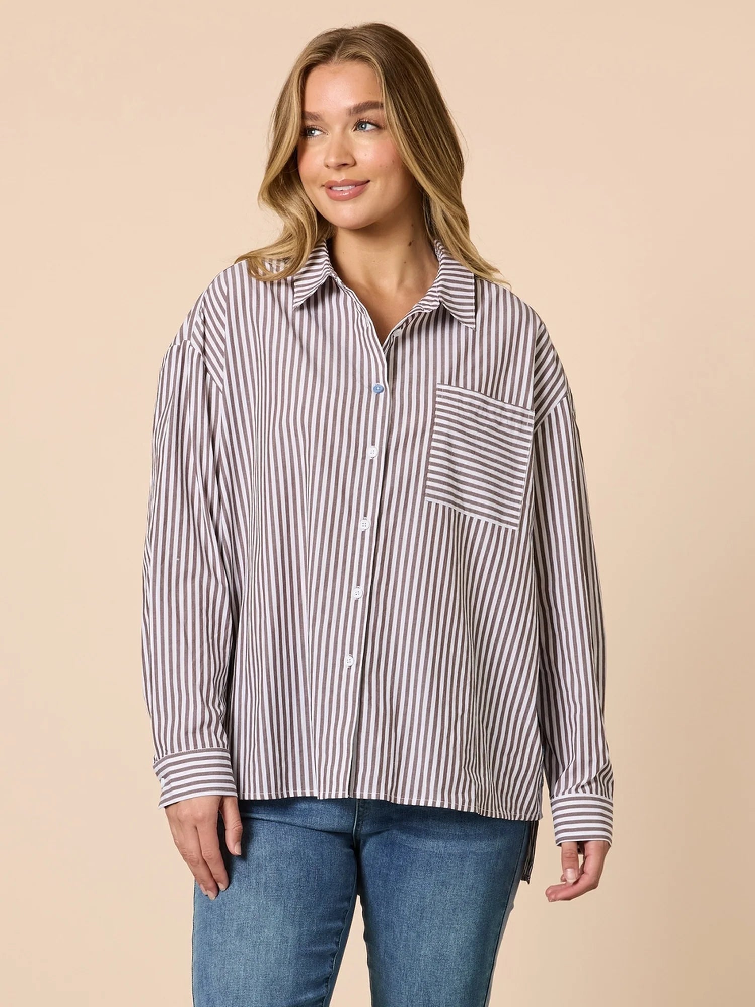 Image of Woman wearing a Threadz striped shirt and jeans on a beige background