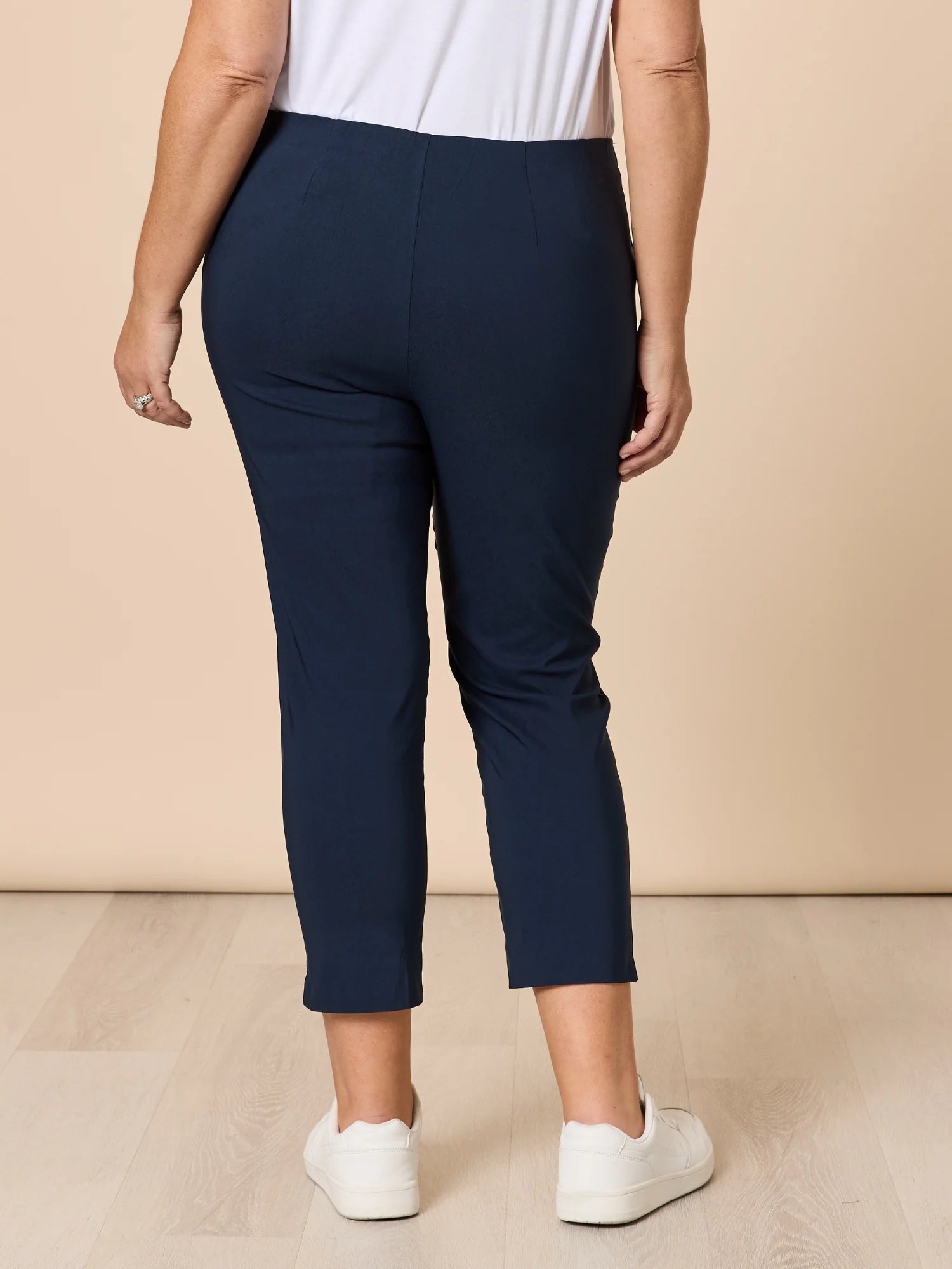 Women wearing Threadz navy blue pants with a beige background