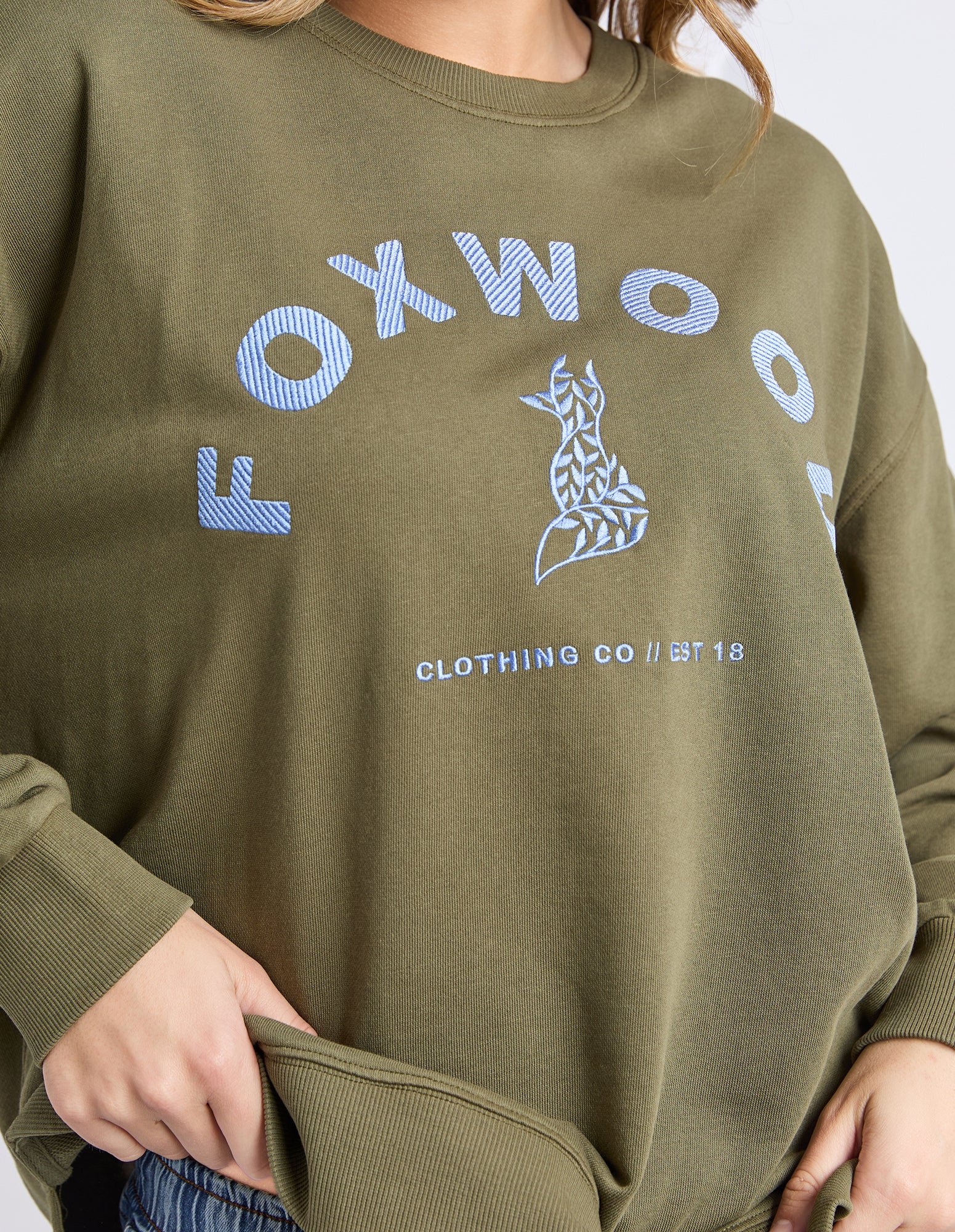 Green jumpert with 'FOXWOOD' branding on a plain background