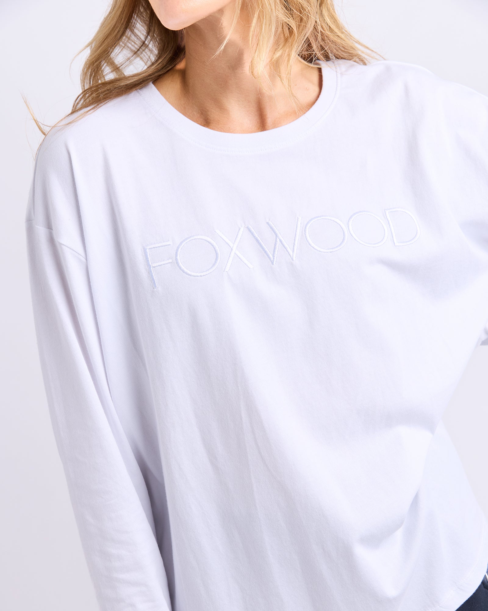 White long-sleeve shirt with 'FOXWOOD' branding on a white background